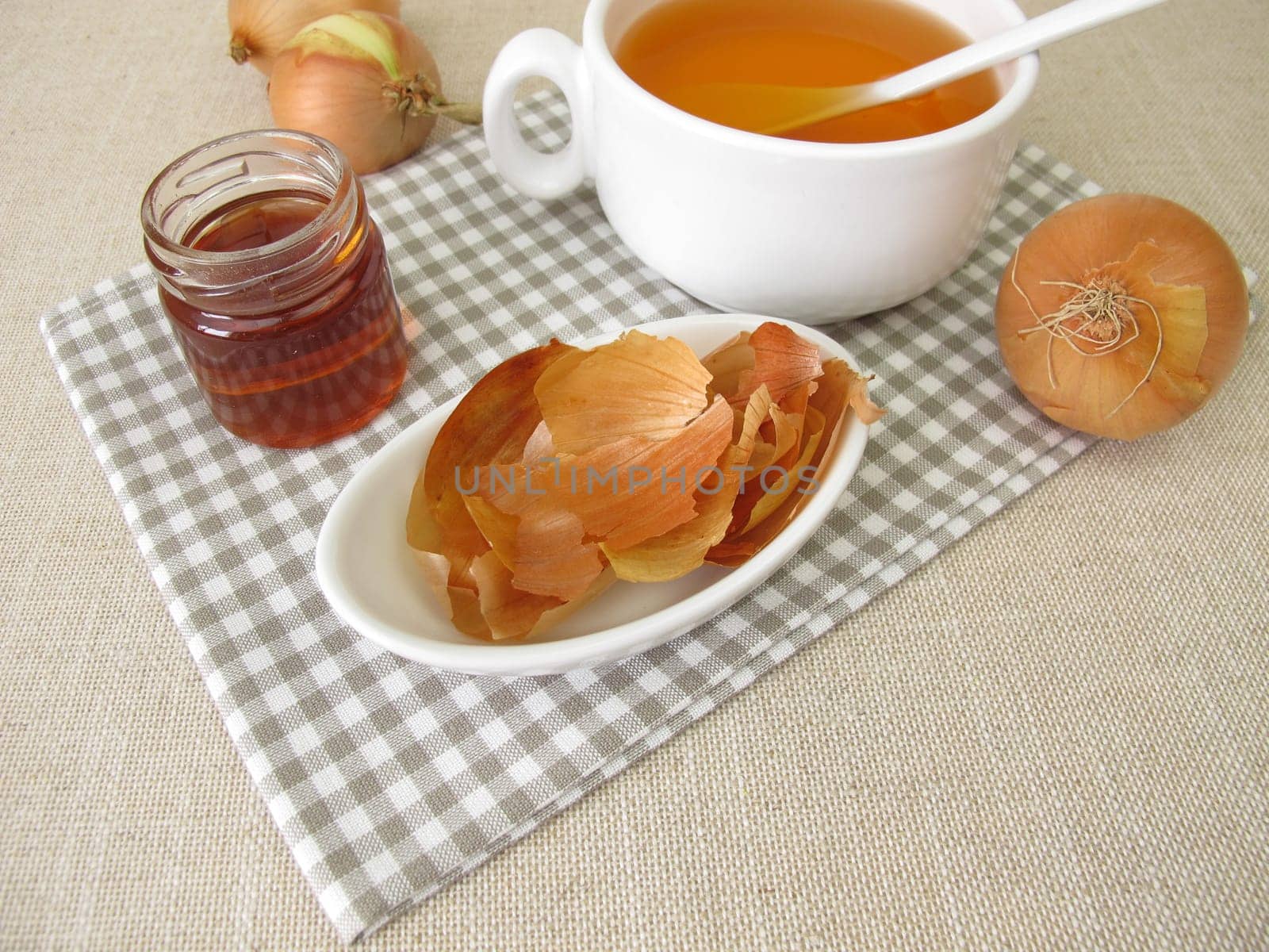 A cup of onion peel tea with honey