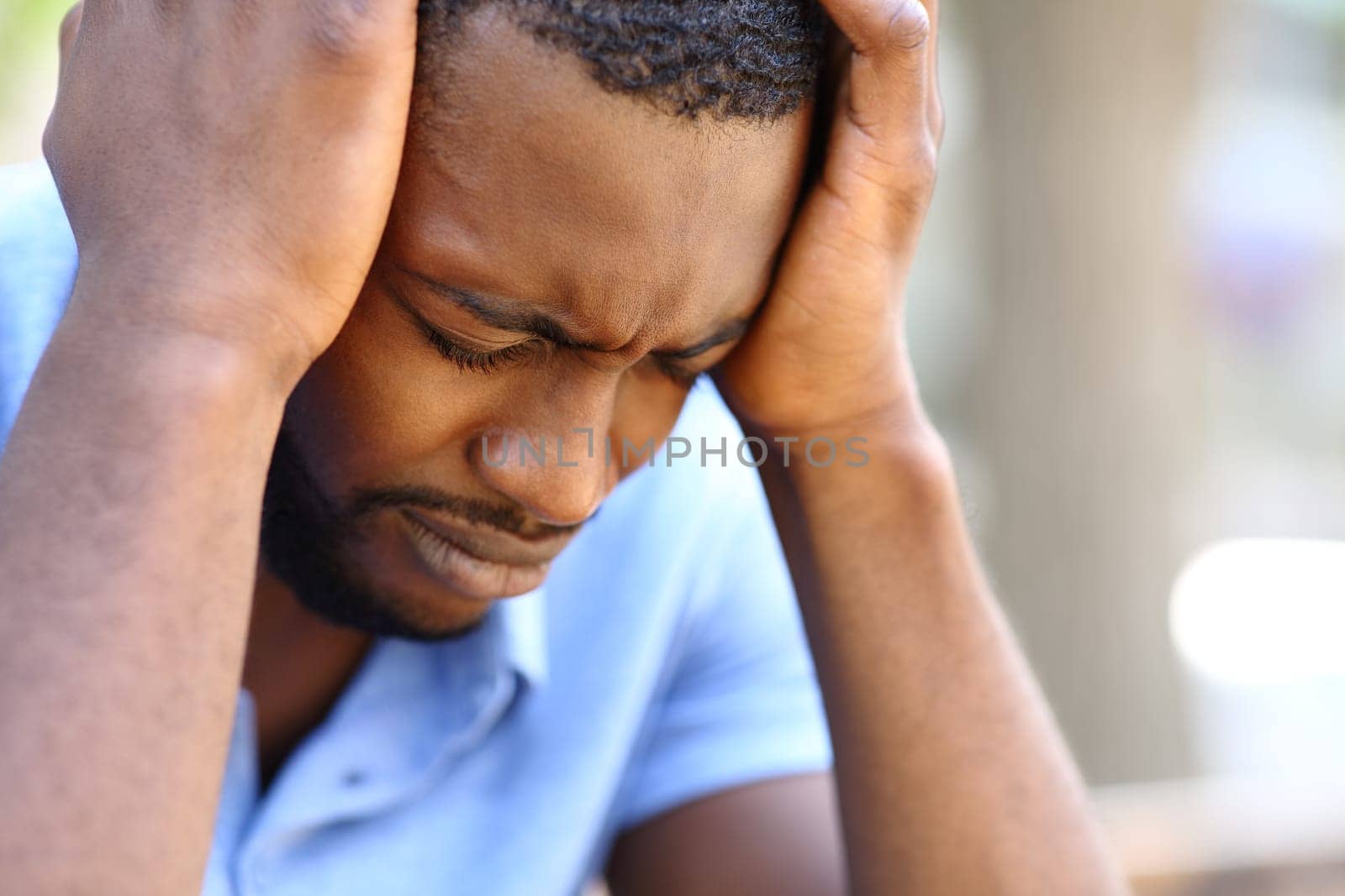 Worried man with black skin complaining alone