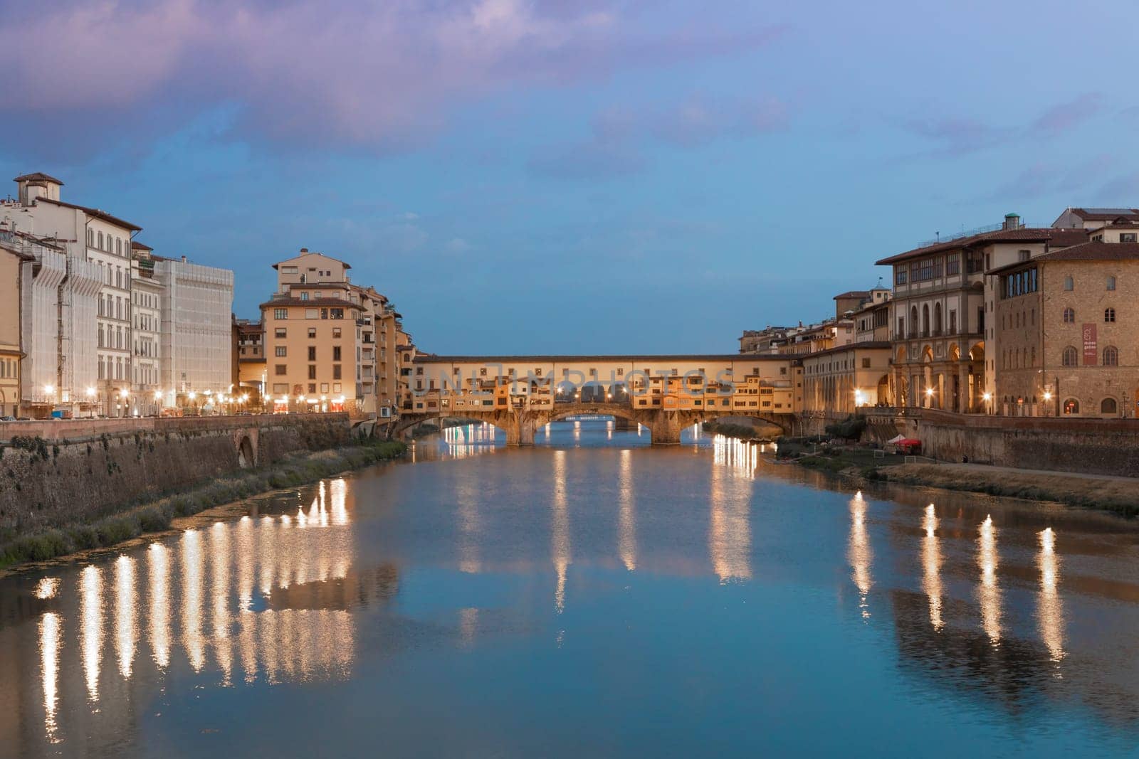 Florence, Italy - circa July 2021. Sunset light on Ponte Vecchio - Old Bridge.