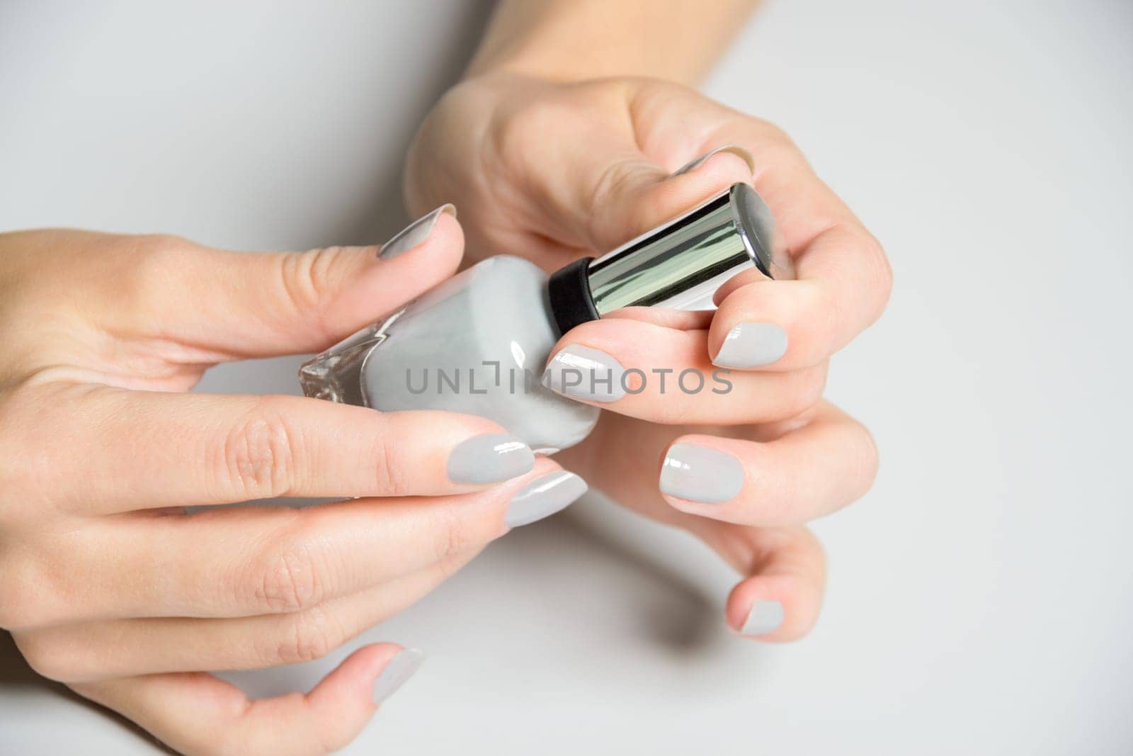 Beautiful woman hands and feet with french manicure. Isolated over white background. Copy space.