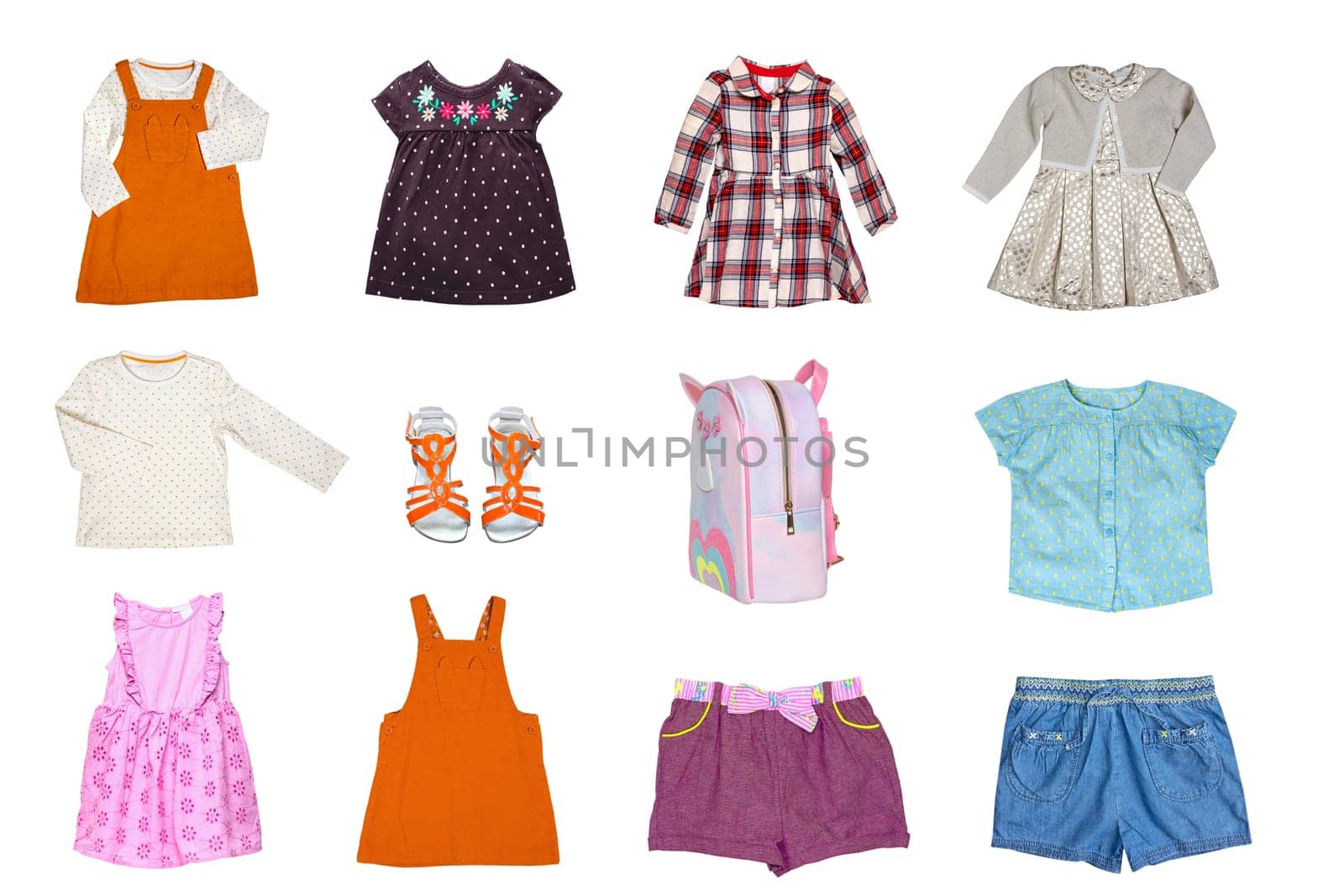 Collage set of little girls summer clothes isolated on a white background. The collection of many stylish dresses, denim shorts, shoes, shirts and a bag.  Children's spring and autumn fashion.