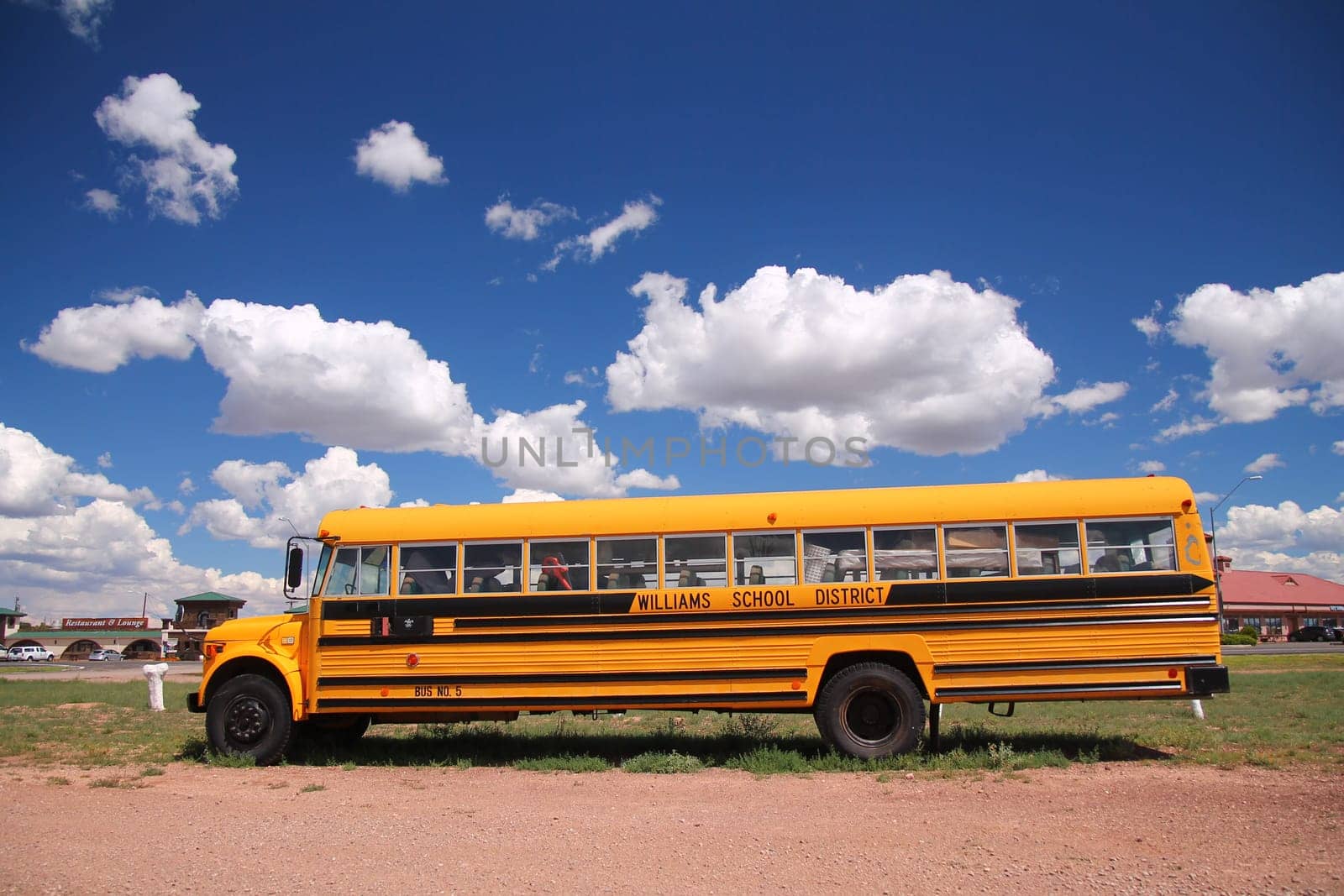 A traditional yellow school bus running its service in the desert of Arizona