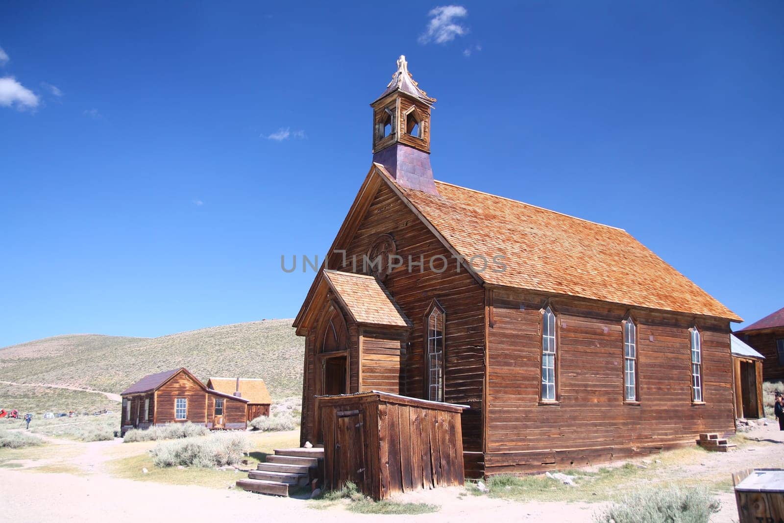 The brown abandoned ghost church of Bodie with the blue sky on the background in California