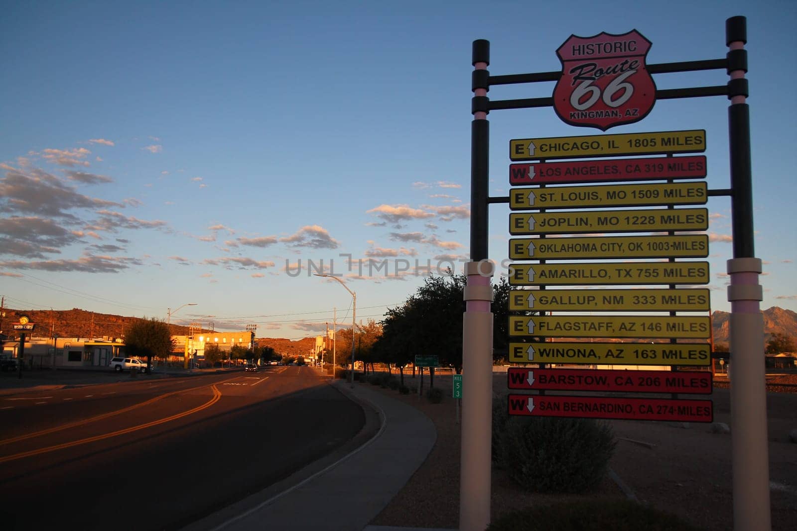 The traffic sign with all the destinations in a orange sunset at Kingman in Arizona