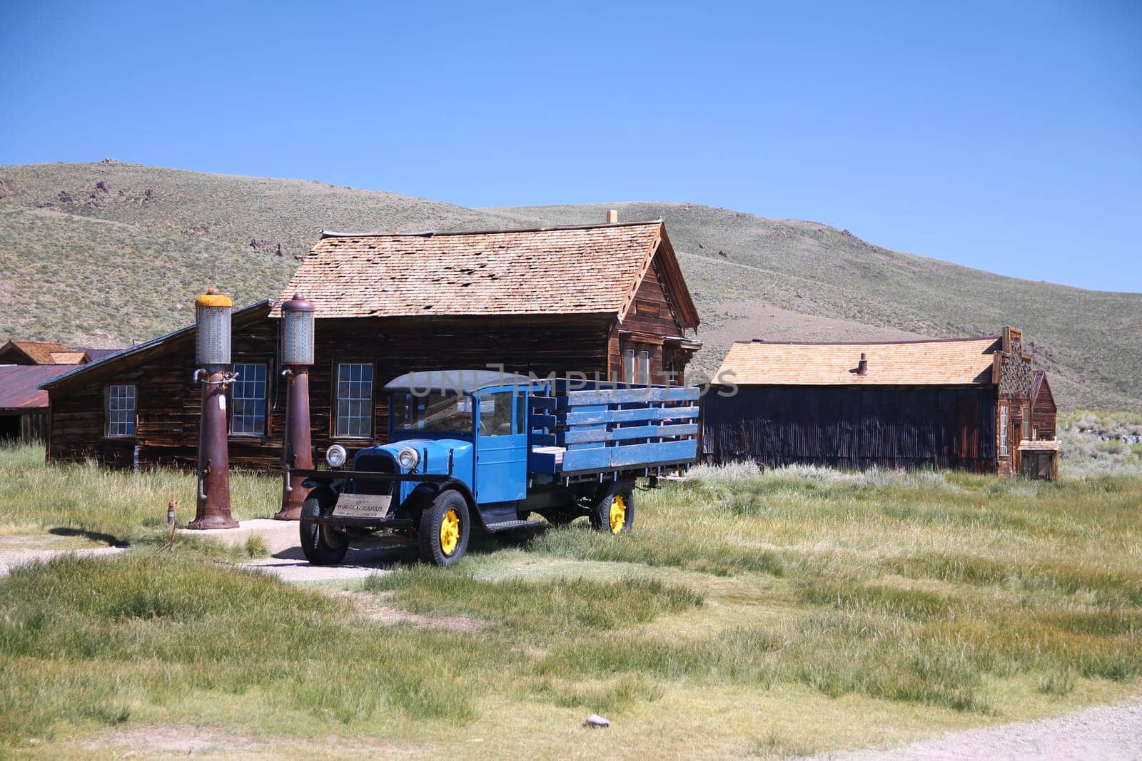 The abandoned gas station and blue truck of the Bodie ghost town in the desert of California