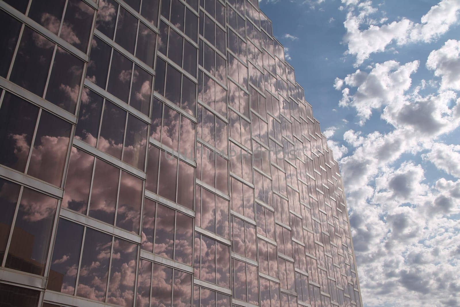 The beauty of the reflections of the clouds in the pink glasses of a skyscraper in the United State of America