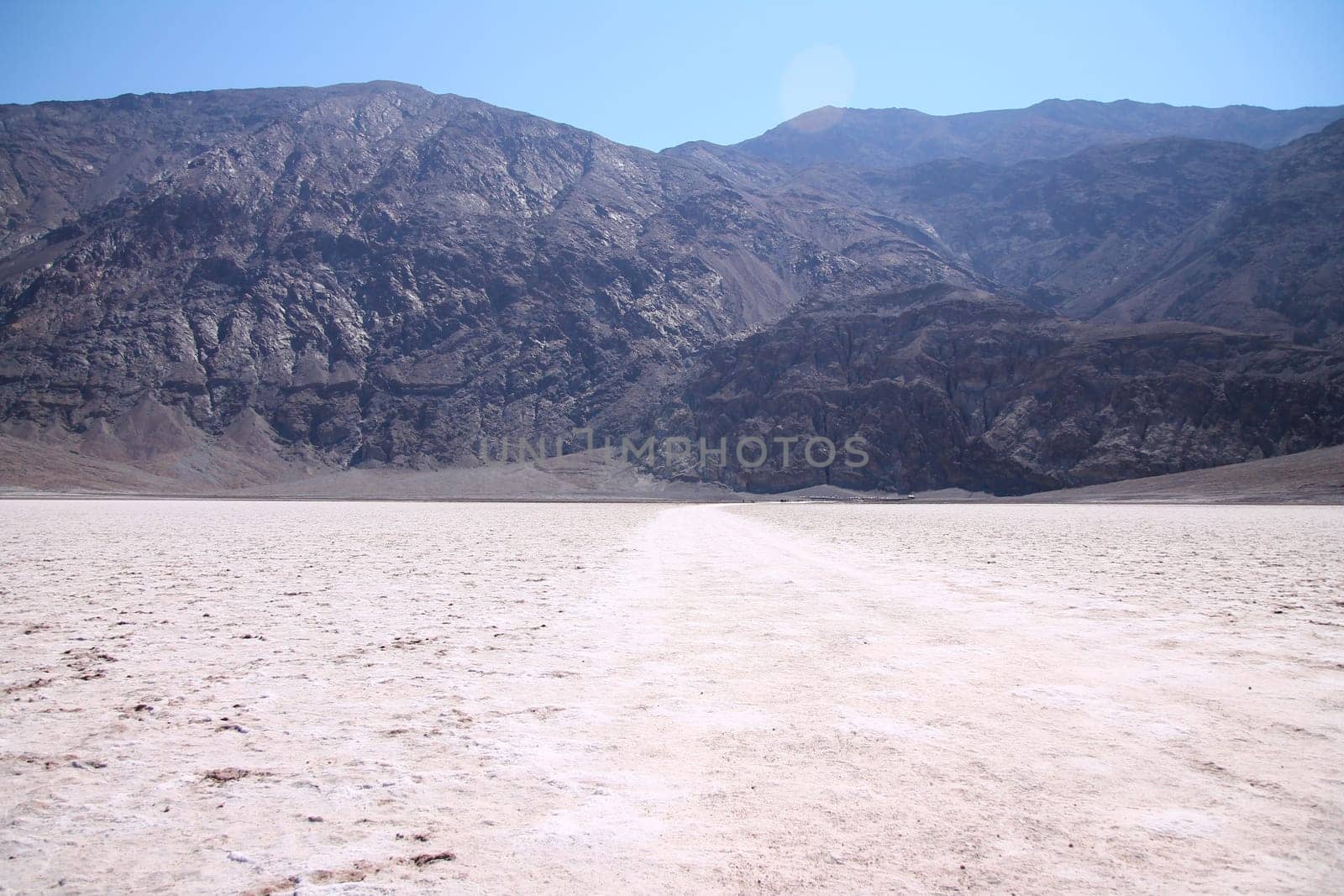 The white salt hot surface of the Badwater Basin in the Death Valley desert in California