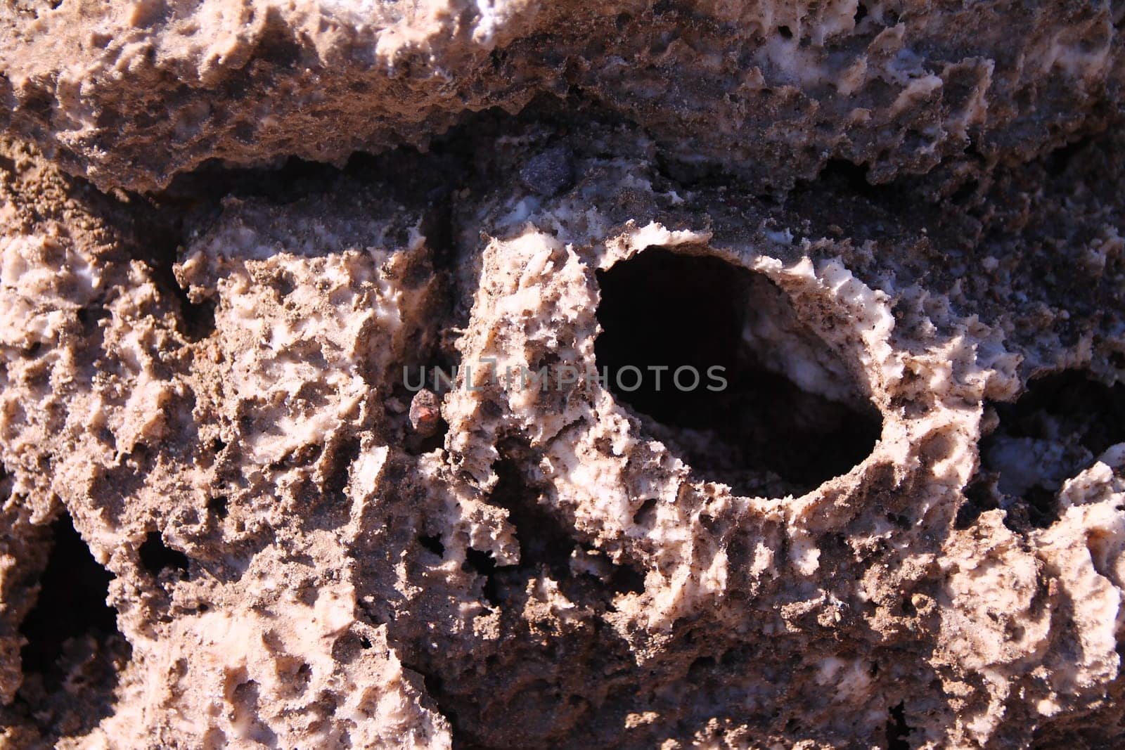 The hole on the salt and rock formation of the Devils Golf Course in the Death Valley in California