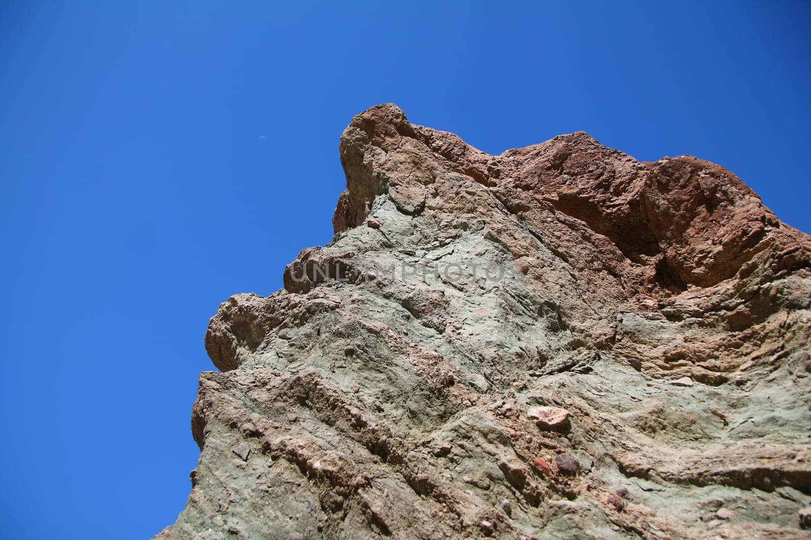 The rocks shaped by thousands of years of history with the blue sky in the Death Valley in California
