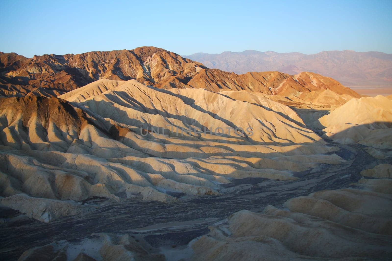 The golden colors of the dunes in the Death Valley desert at sunrise in California