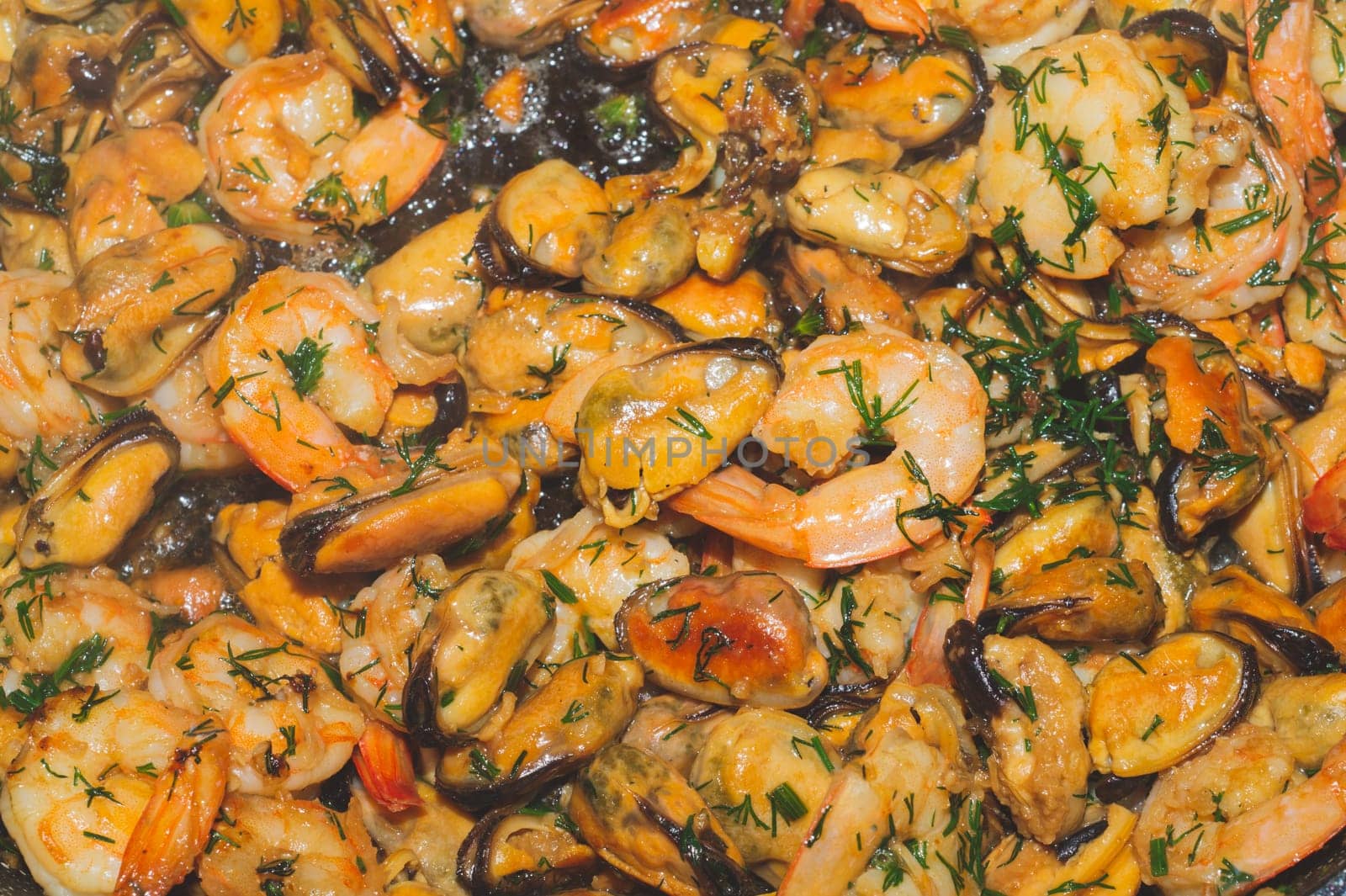 Fried prawns and mussels. grilled seafood close up. cooking process