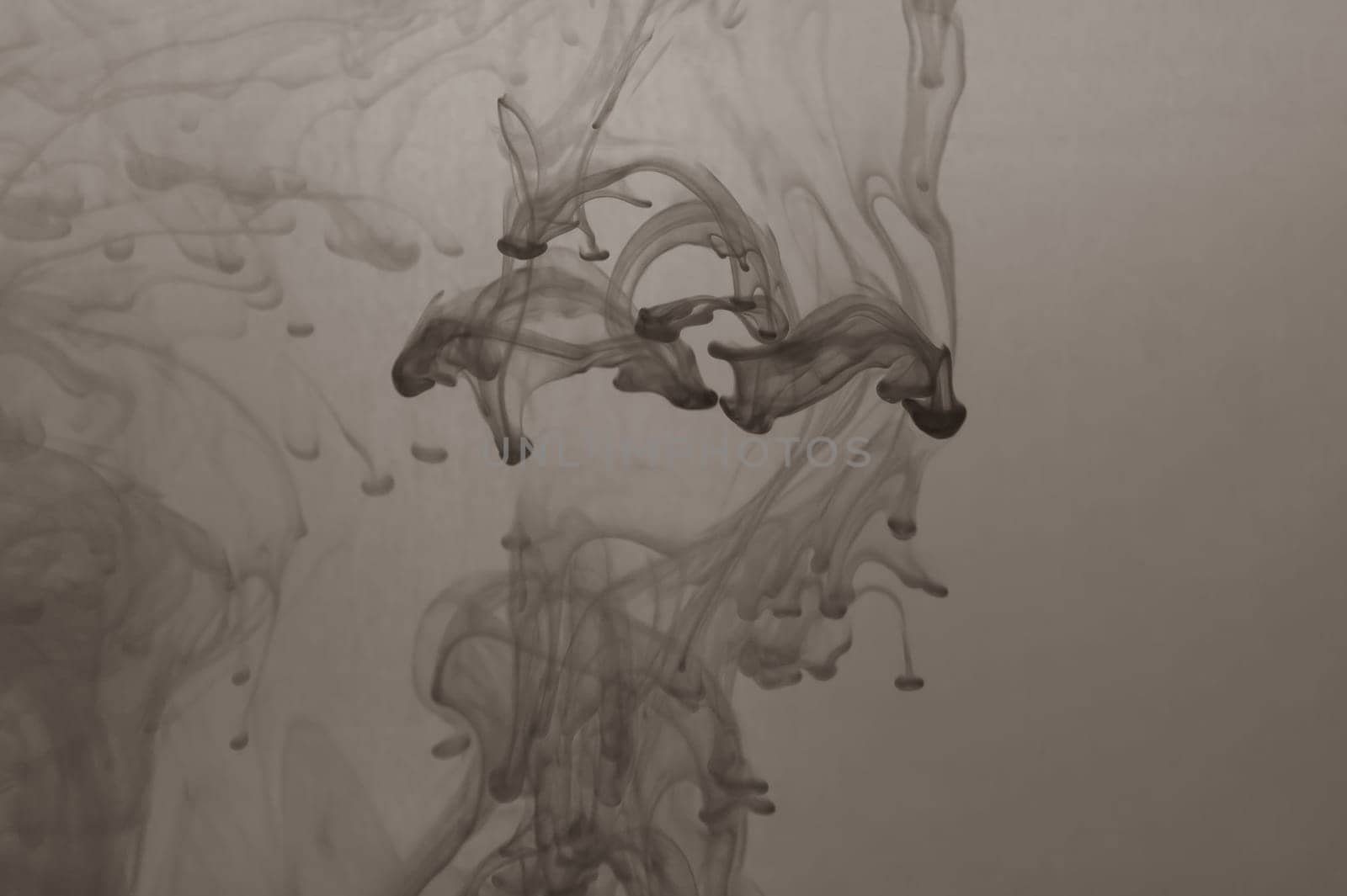 Ink in the water abstract background. splashes of paint swirling in liquid. black and white