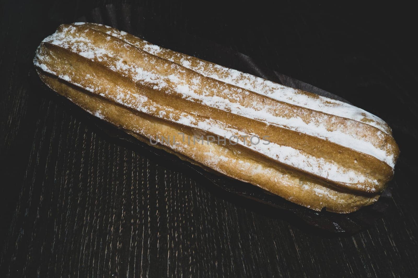 Eclairs with powdered sugar. sweet dessert close up