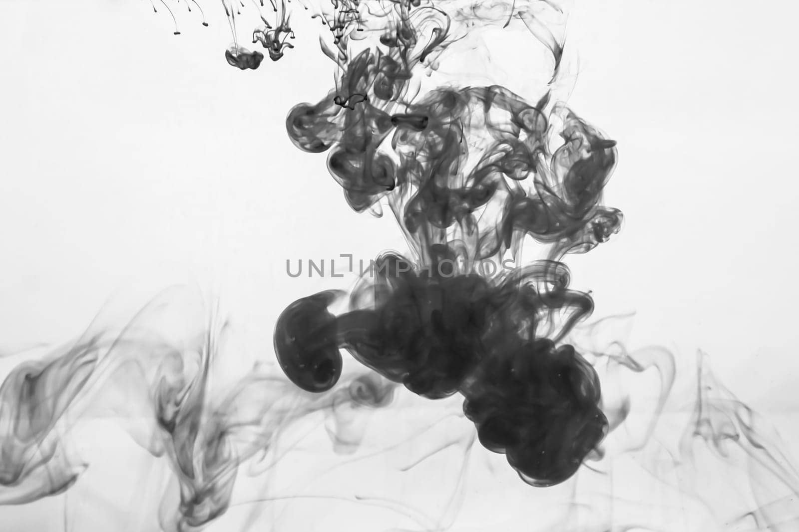 Ink in the water abstract background. splashes of paint swirling in liquid. black and white