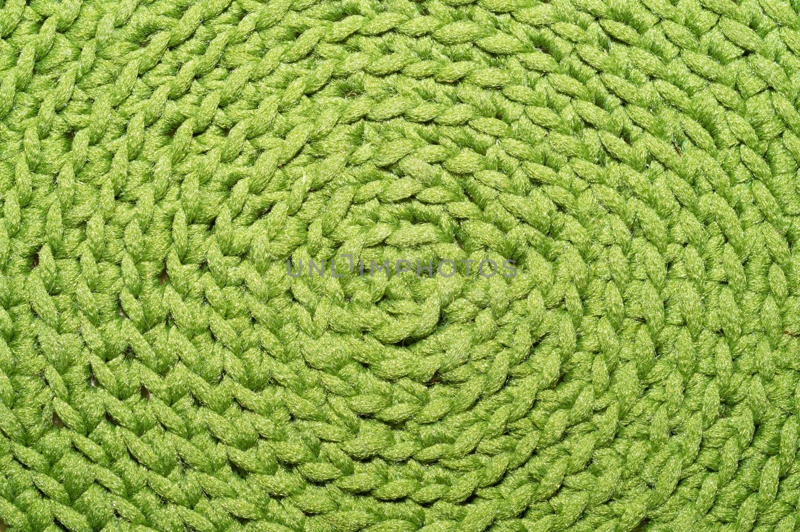 Knitted background close up. green woolen fabric macro