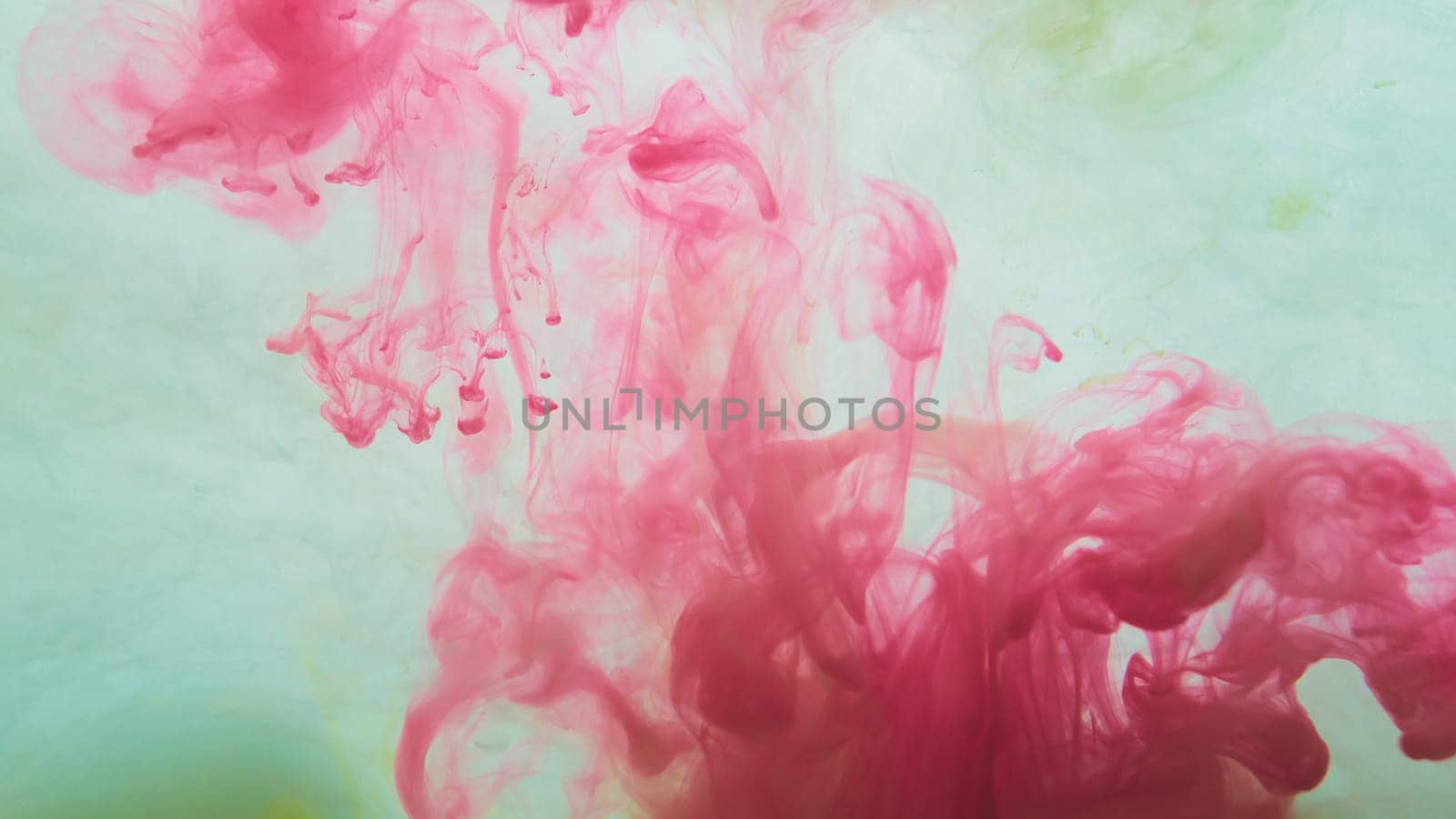 Red paint in the water. ink in fluid. abstract background. colorful splashes in liquid