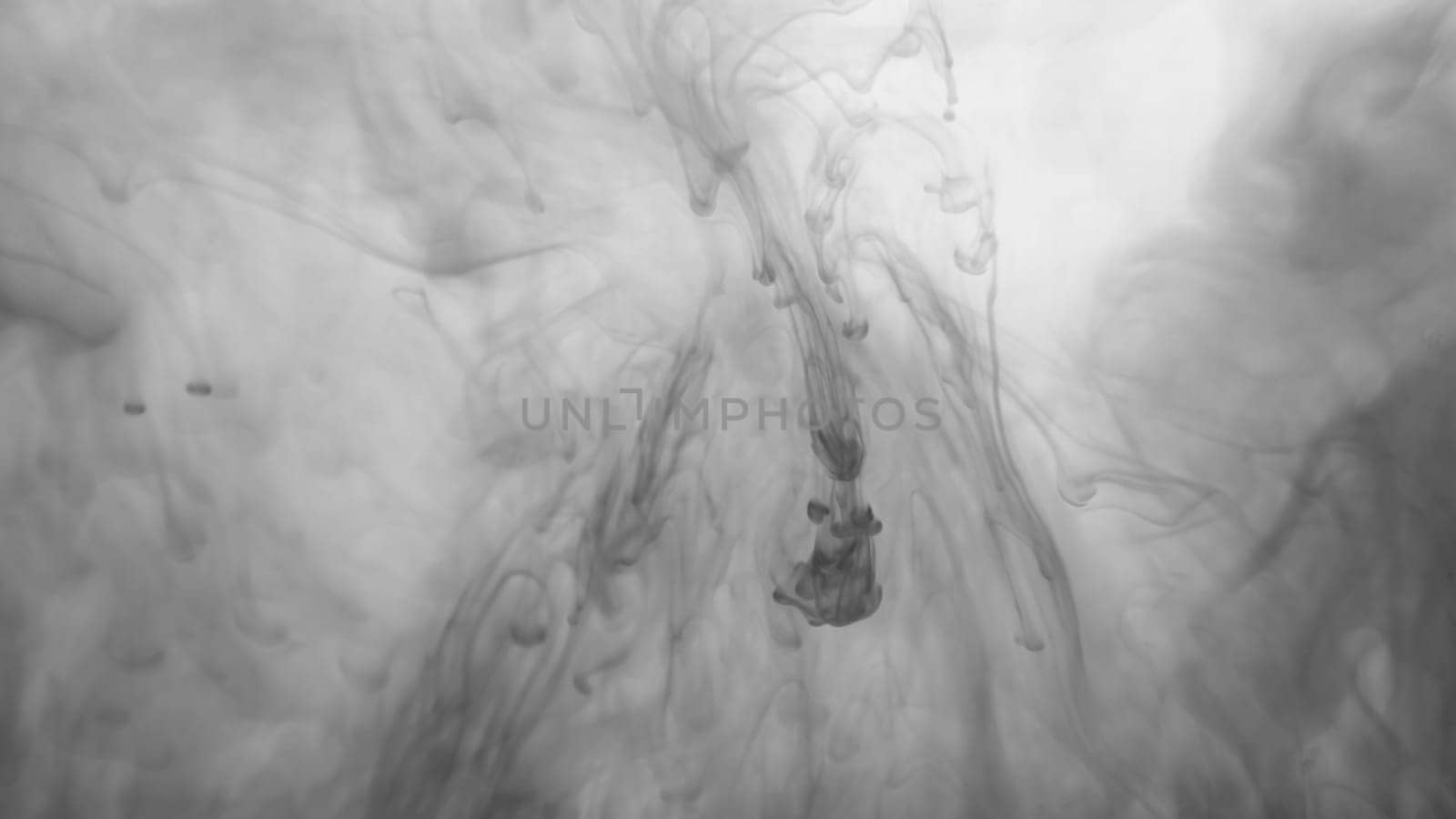 Ink in the water abstract background. splashes of paint swirling in liquid. black and white