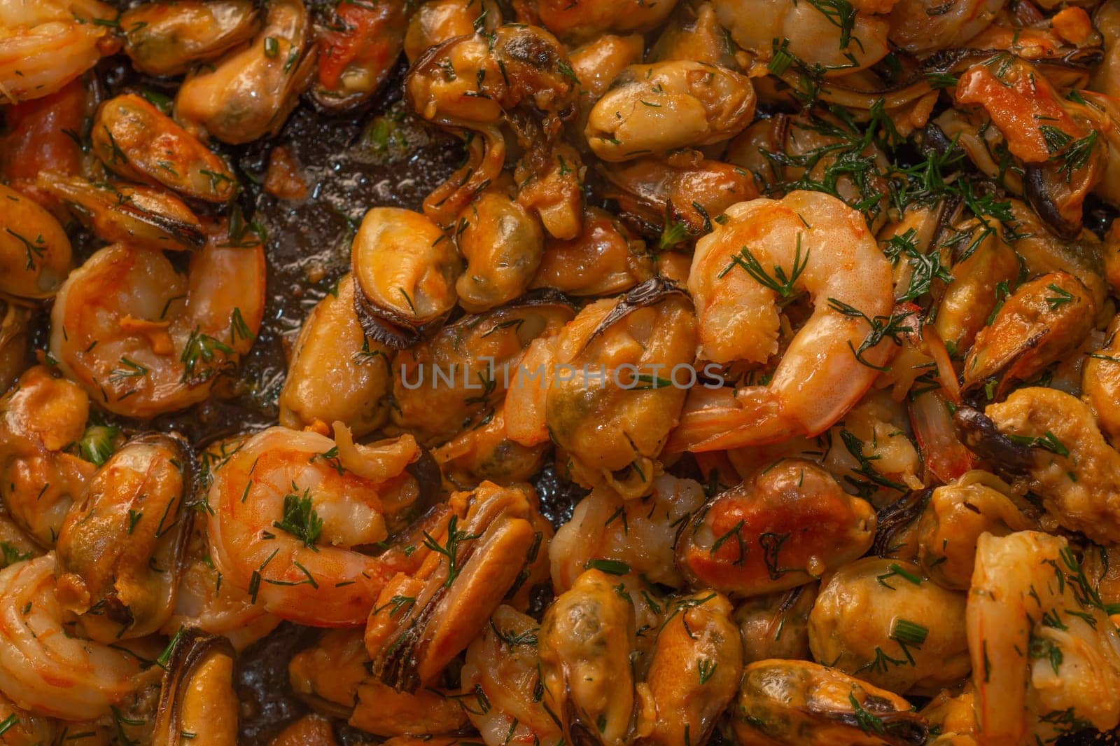 Fried prawns and mussels. grilled seafood close up. cooking process