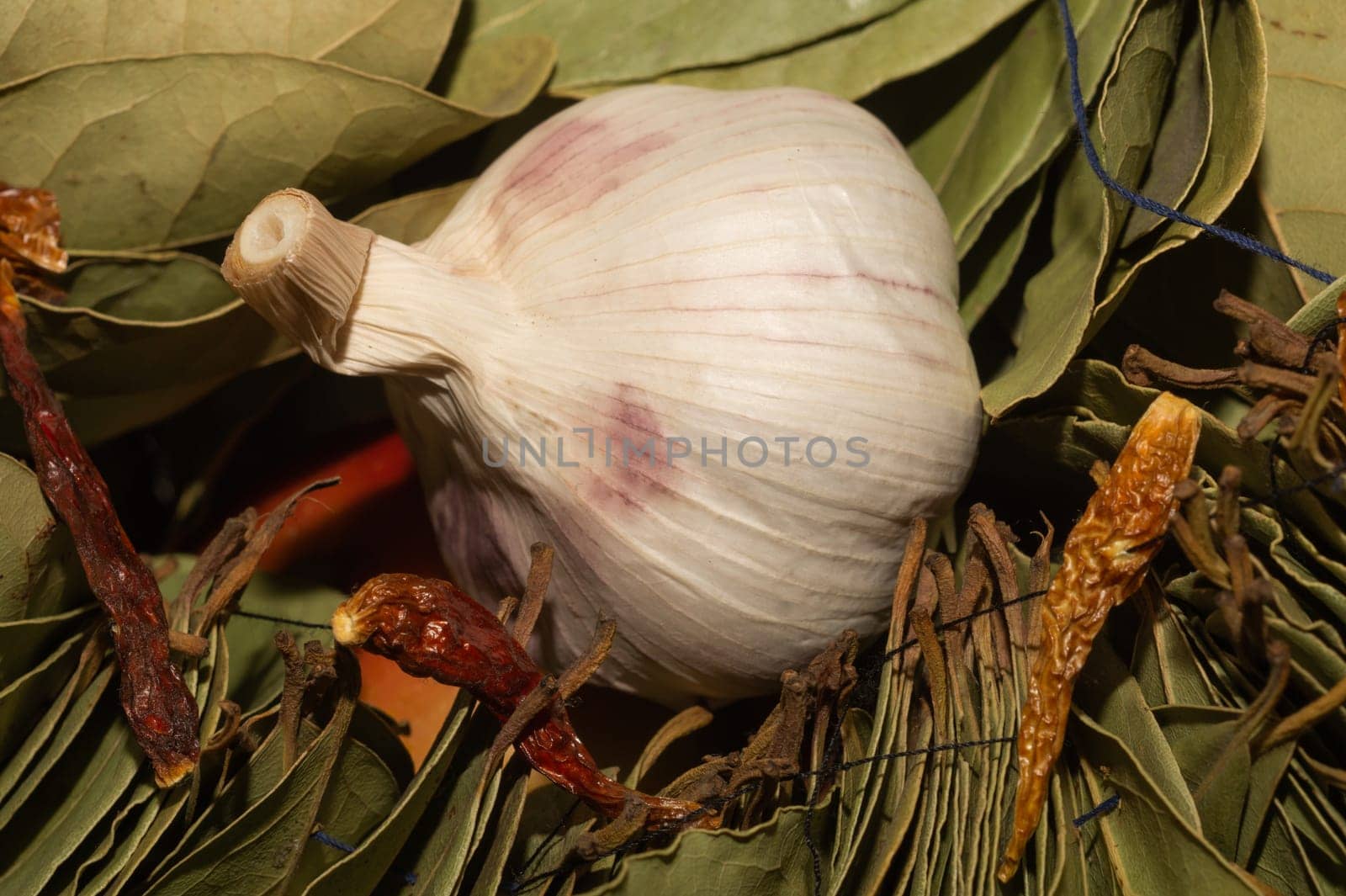 Garlic and bay leaves. dried hot peppers close up