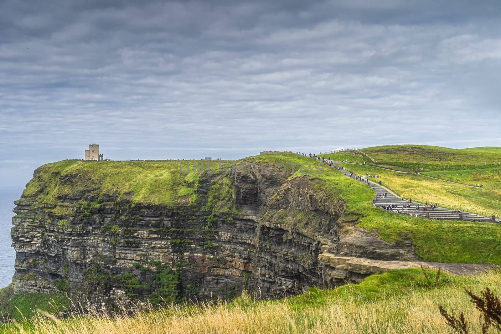 Crowds of tourists walking on stairs to OBriens Tower on iconic Cliffs of Moher, popular tourist attraction, UNESCO, Wild Atlantic Way, Clare, Ireland