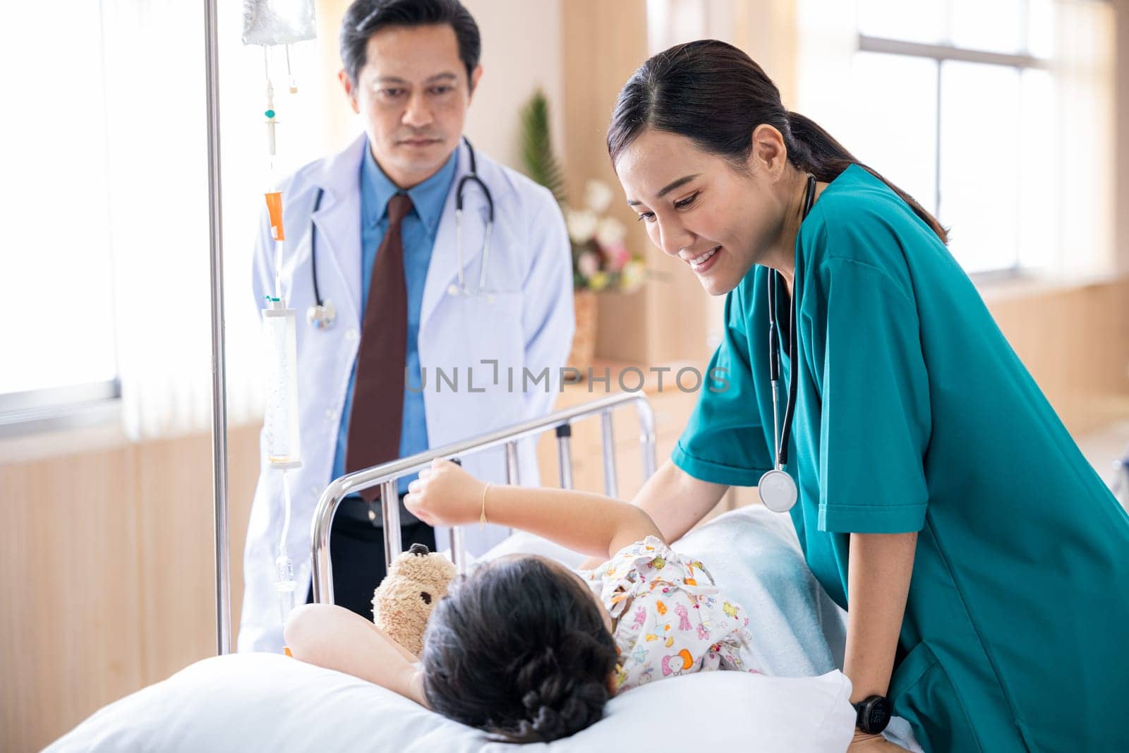 Pediatrician visiting parents and child in hospital bed ward, doctor and nurse meet and talking with patient kid, healthcare medical service treatment process concept