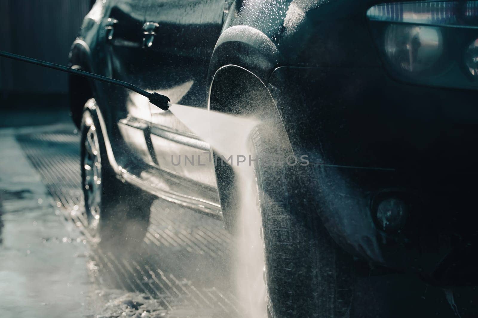 Car wash with pressurized water in car wash outside.