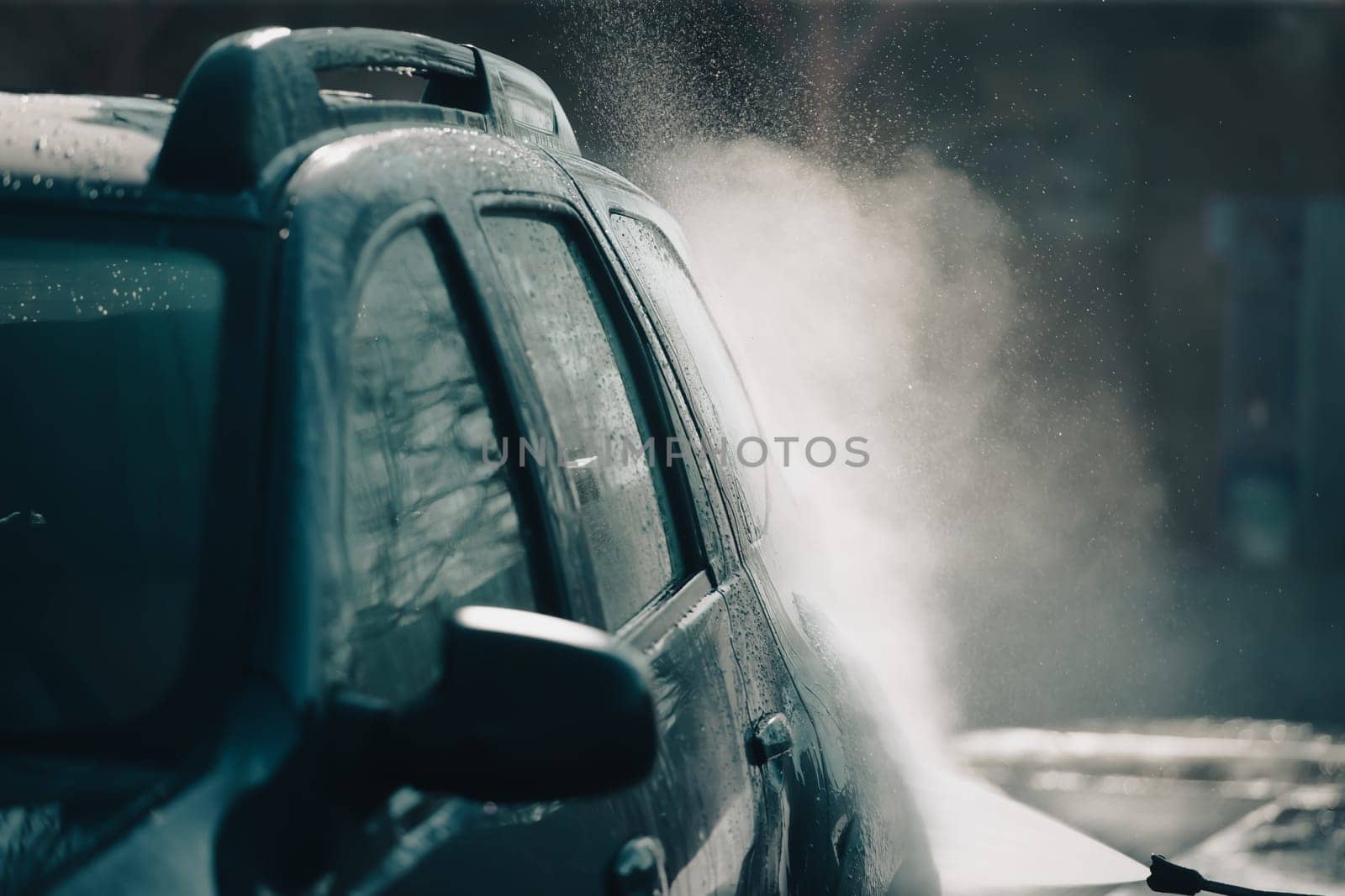 Car wash with pressurized water in car wash outside.