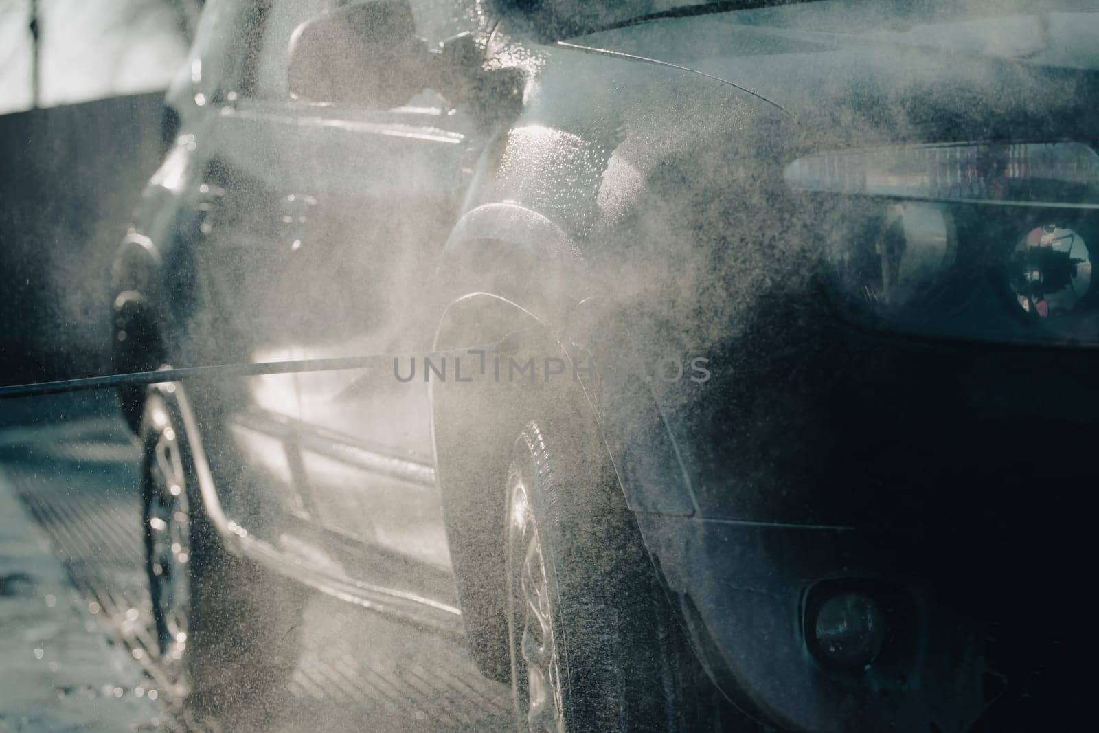 Car wash with pressurized water in car wash outside.
