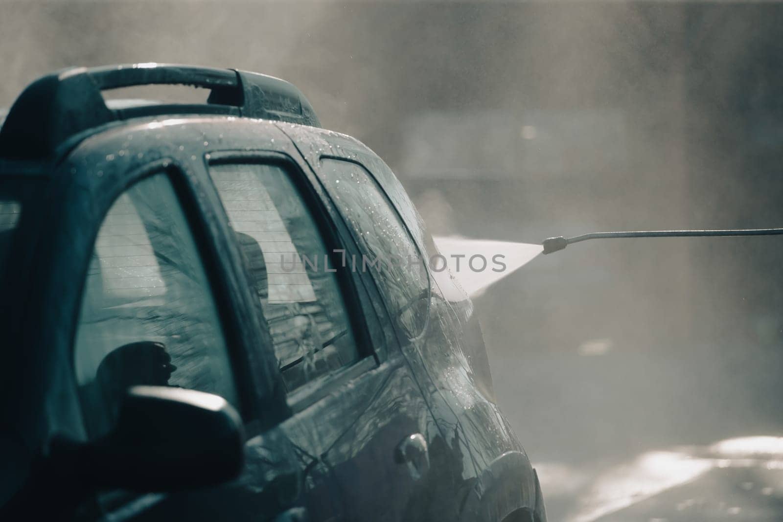 Car wash with pressurized water in car wash outside.
