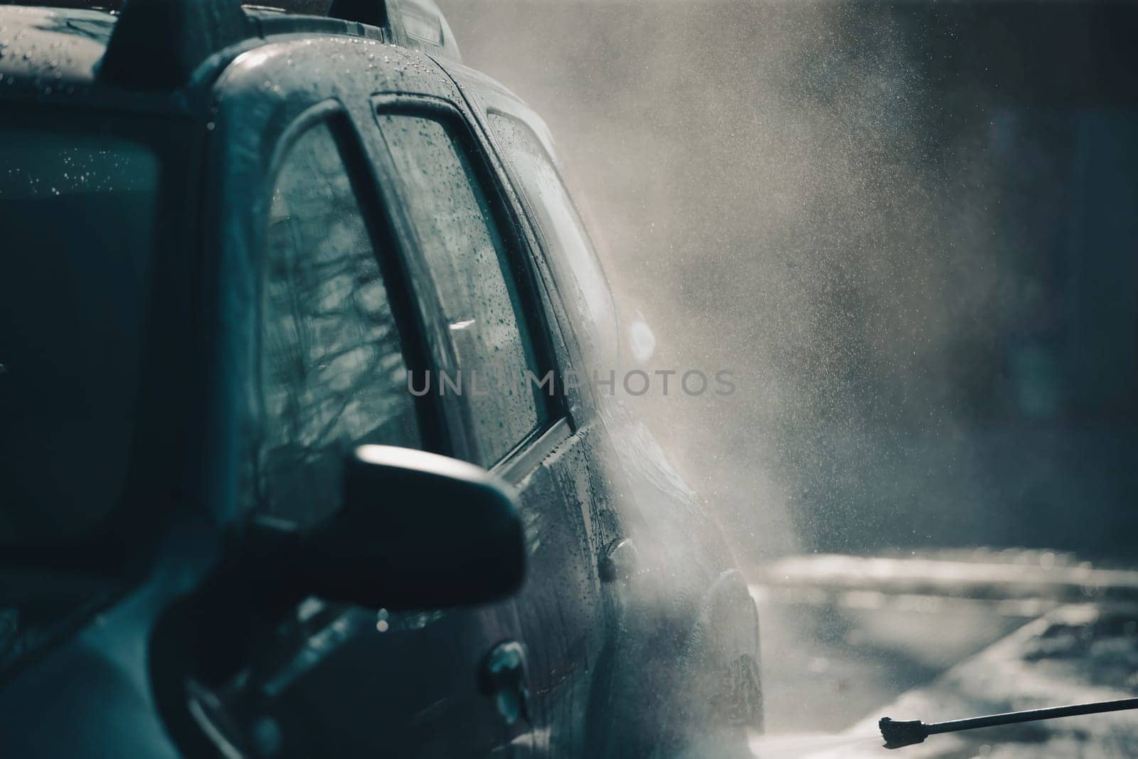 Car wash with pressurized water in car wash outside.