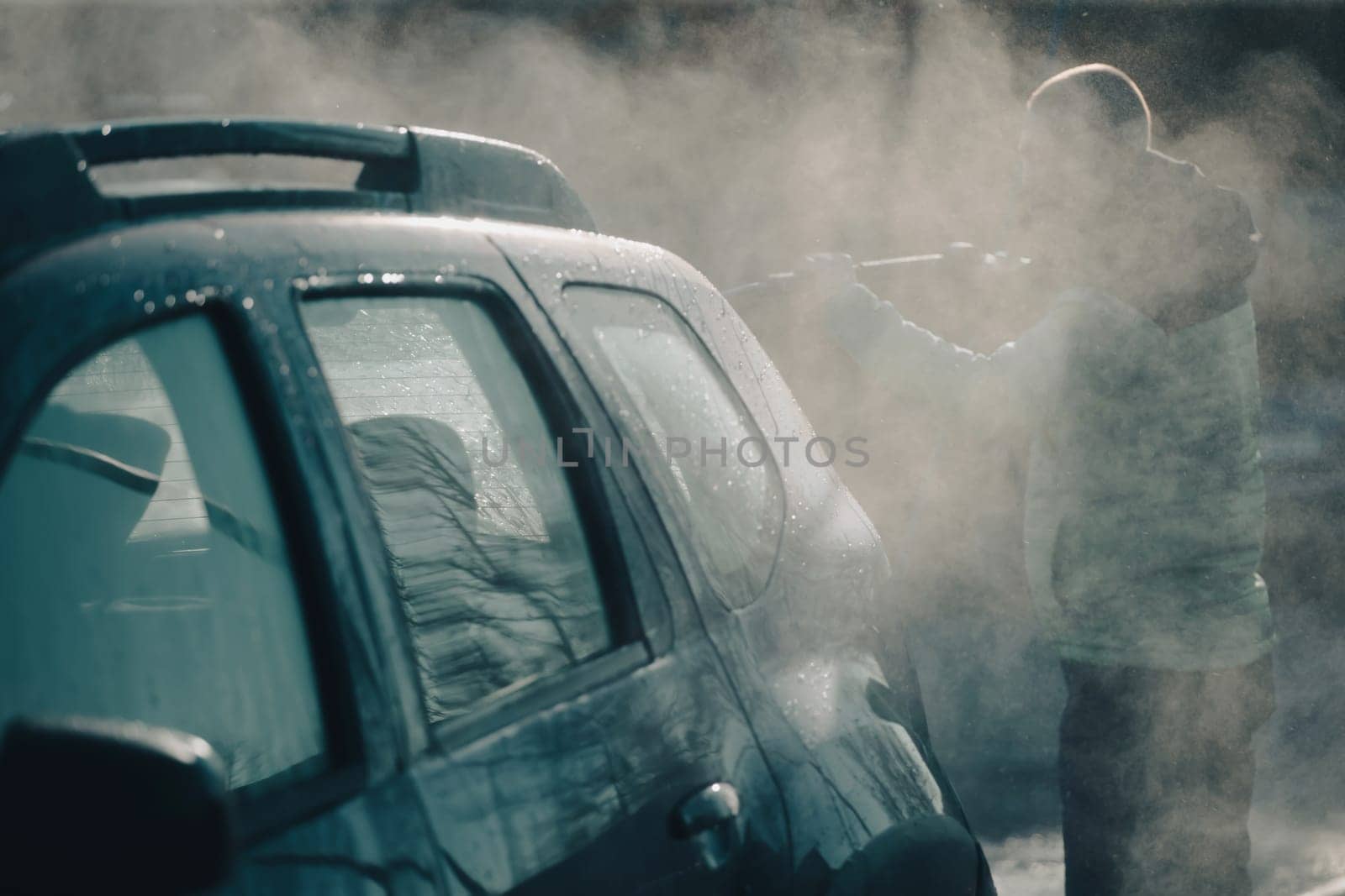 Car wash with pressurized water in car wash outside.