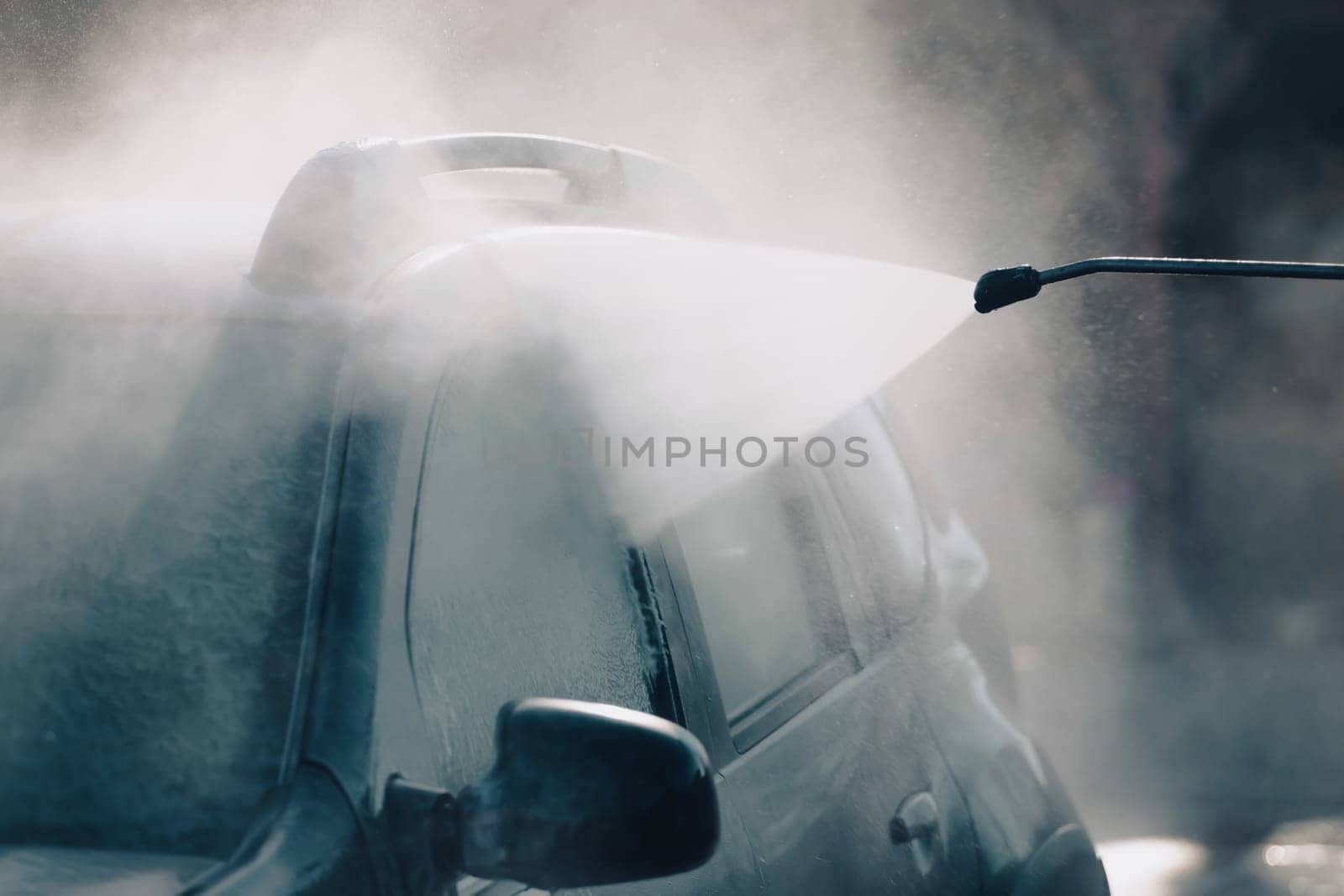Car wash with pressurized water in car wash outside.