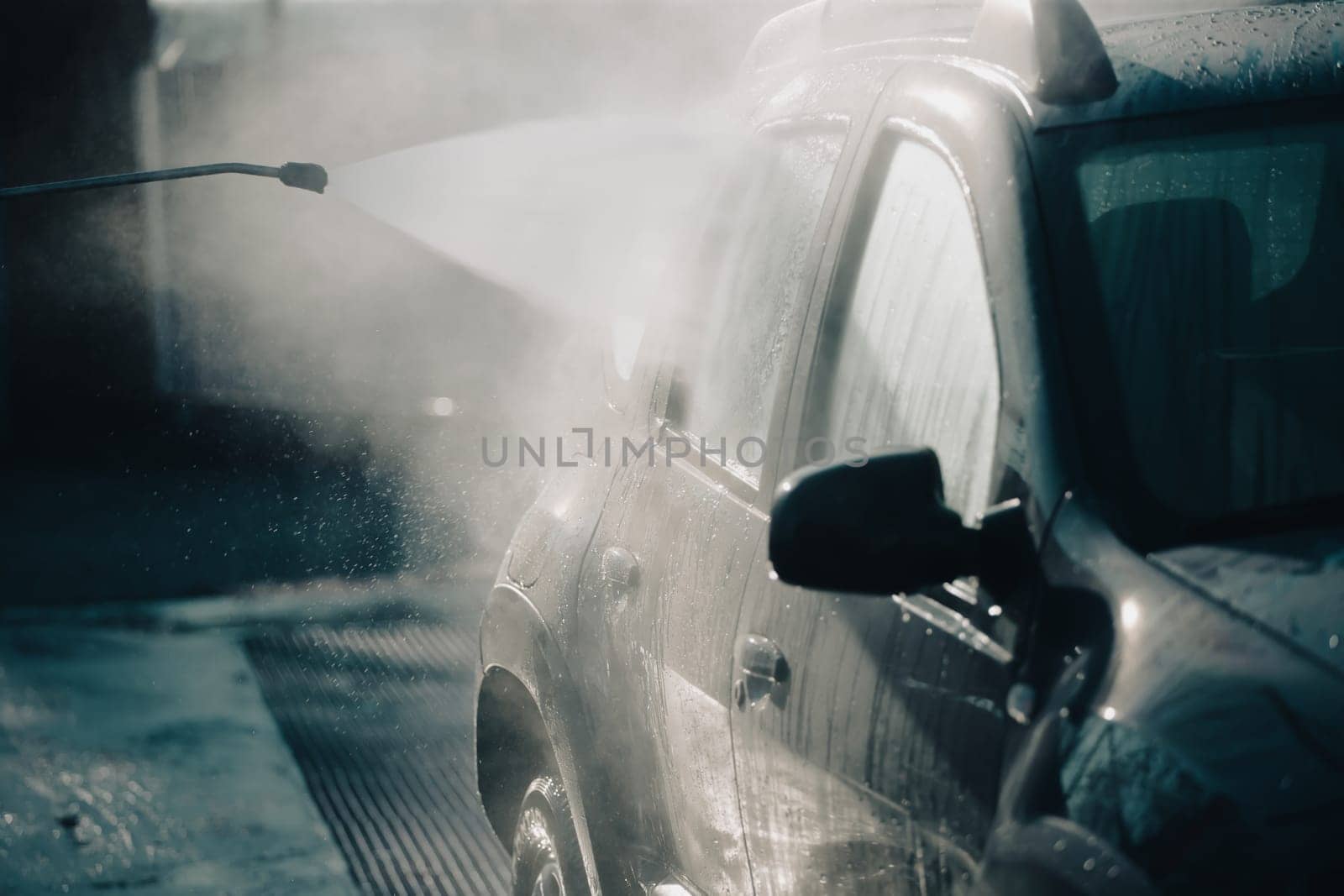Car wash with pressurized water in car wash outside.