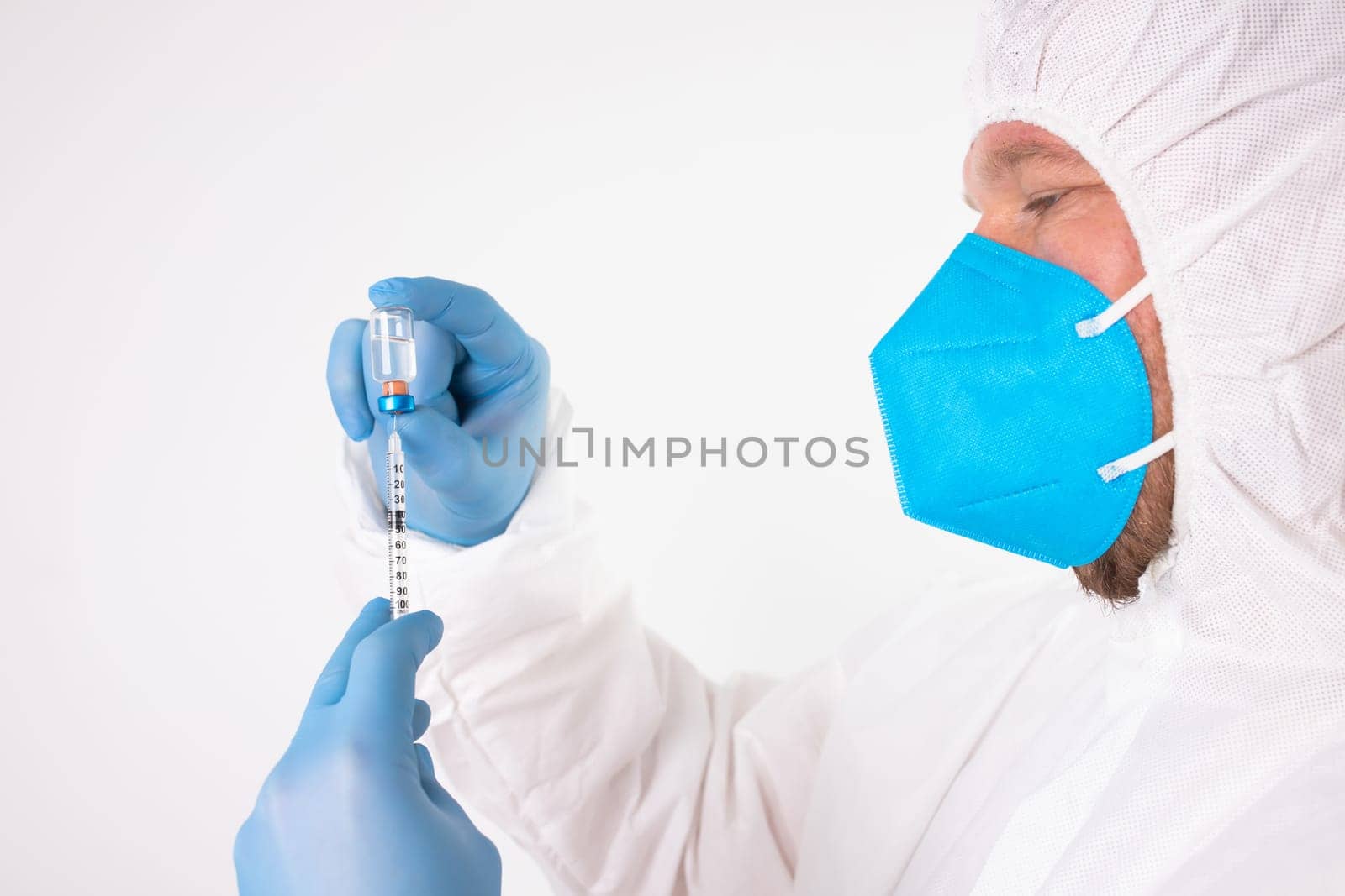 COVID-19 coronavirus vaccine. Vaccination concept. Doctor's hand in blue gloves hold medicine vaccine vial bottle and syringe.