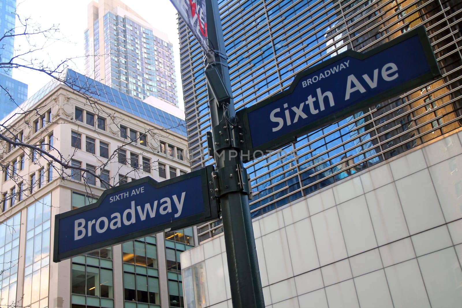 Blue Sixth Avenue and Broadway historic sign in Midtown Manhattan in New York City