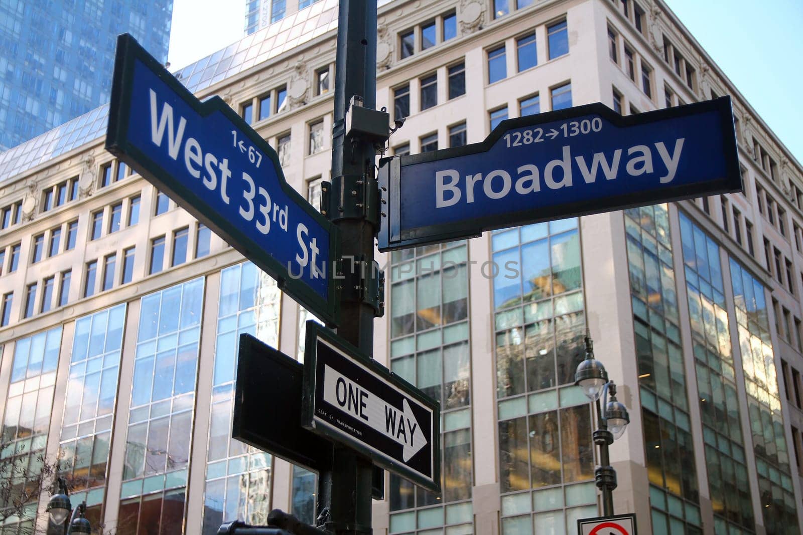 Blue West 33rd Street and Broadway historic sign in Midtown Manhattan in New York City