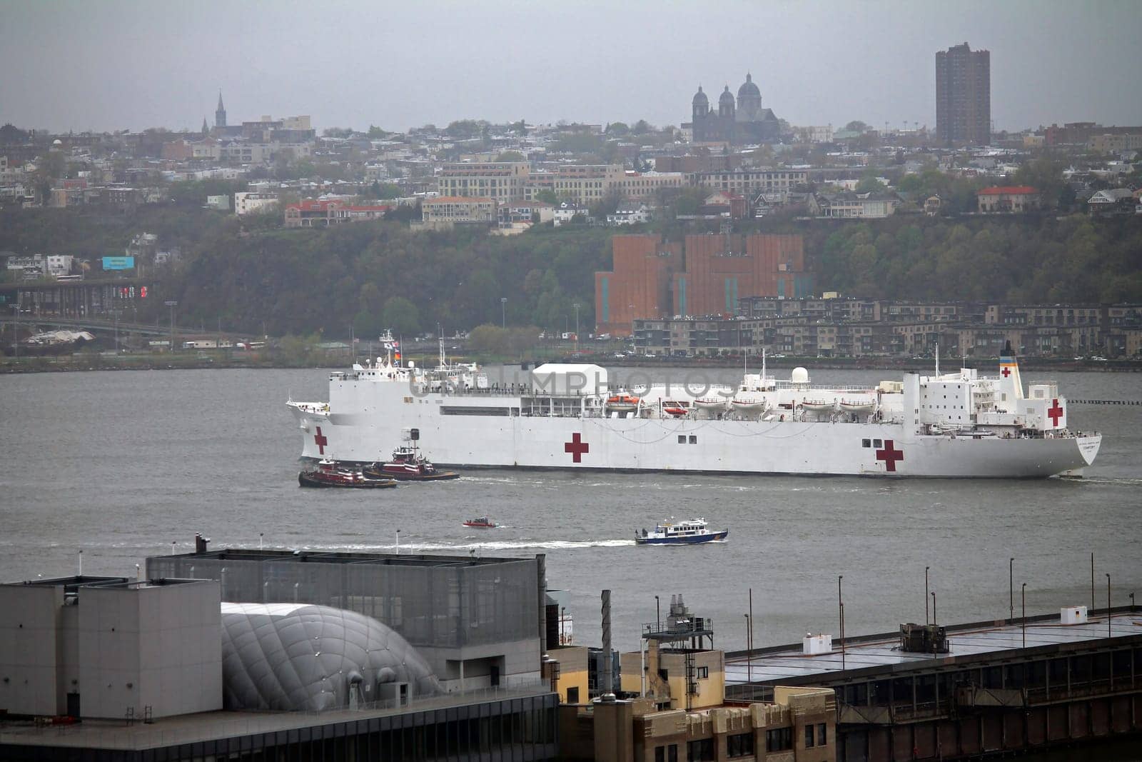 Navy hospital ship Comfort floating through the skyscrapers on the Hudson river in New York City