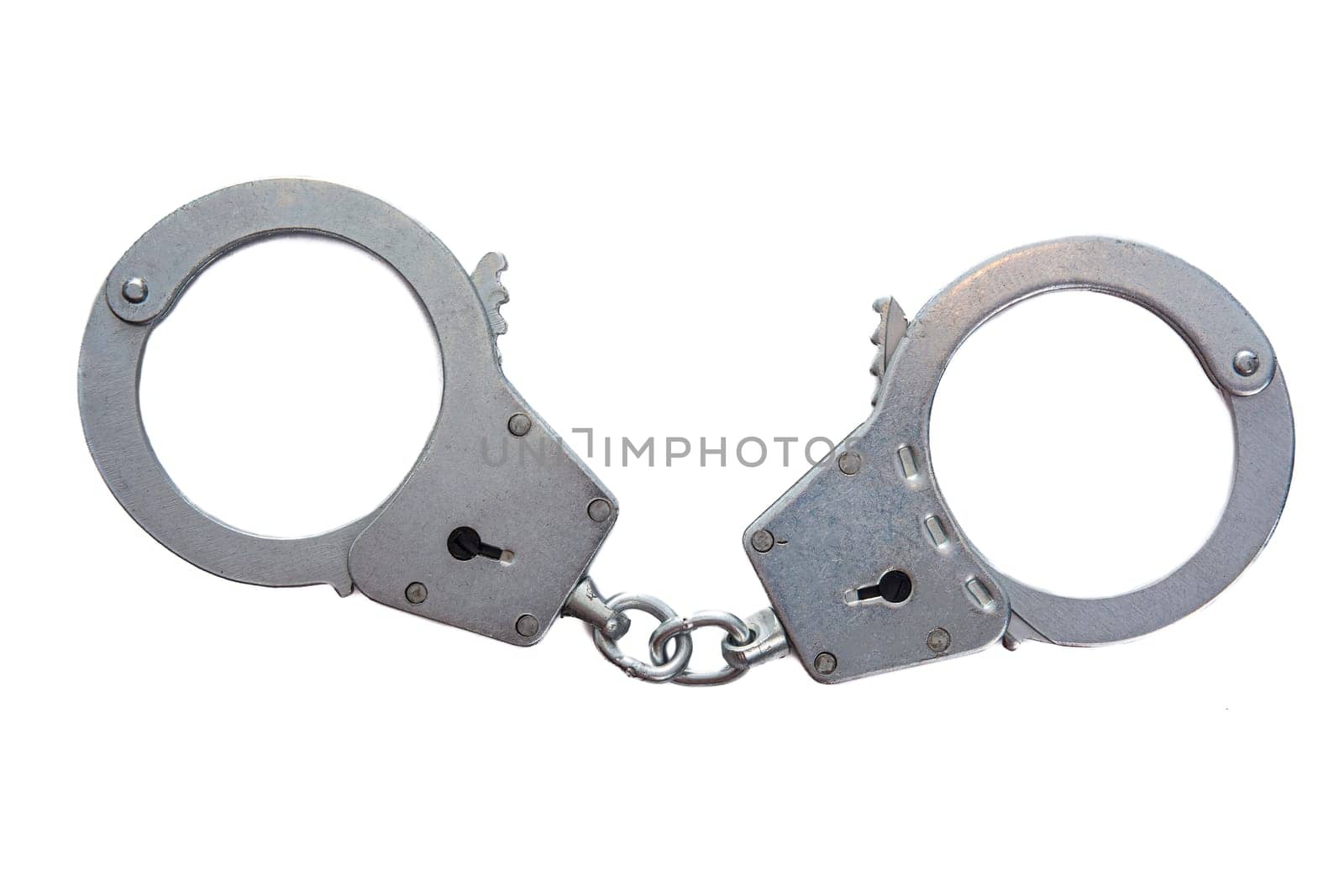 Metal handcuffs on a white isolated background. High quality photo