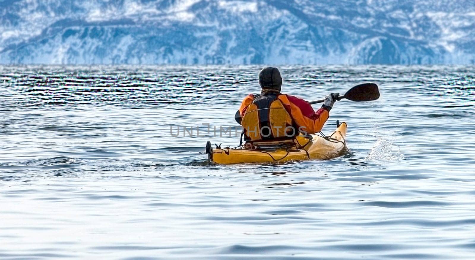 The kayaker on a boat in the calm sea on Kamchatka Peninsula