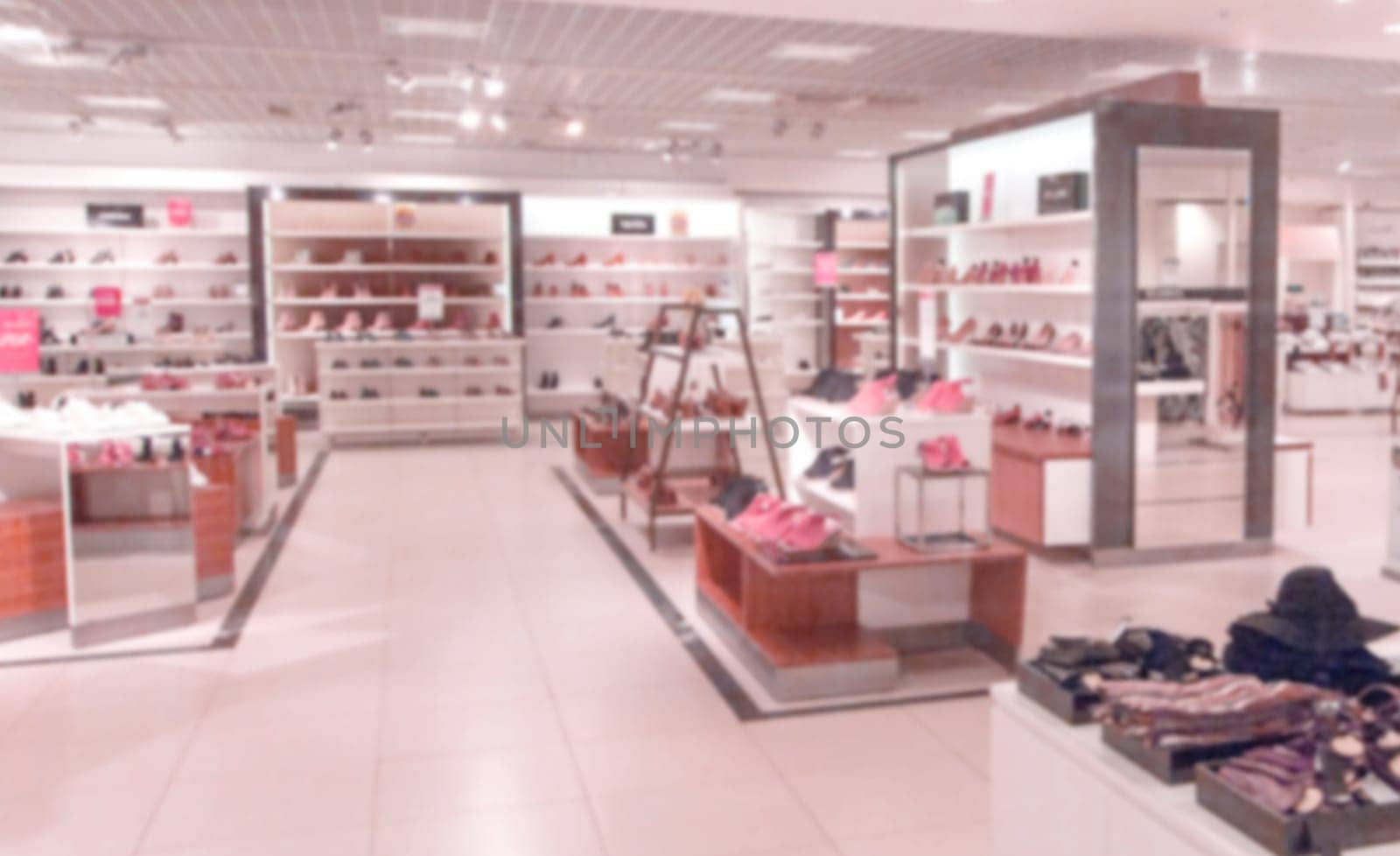 The abstract blur vintage style clothing store displaying woman's fashion in the mall super center.