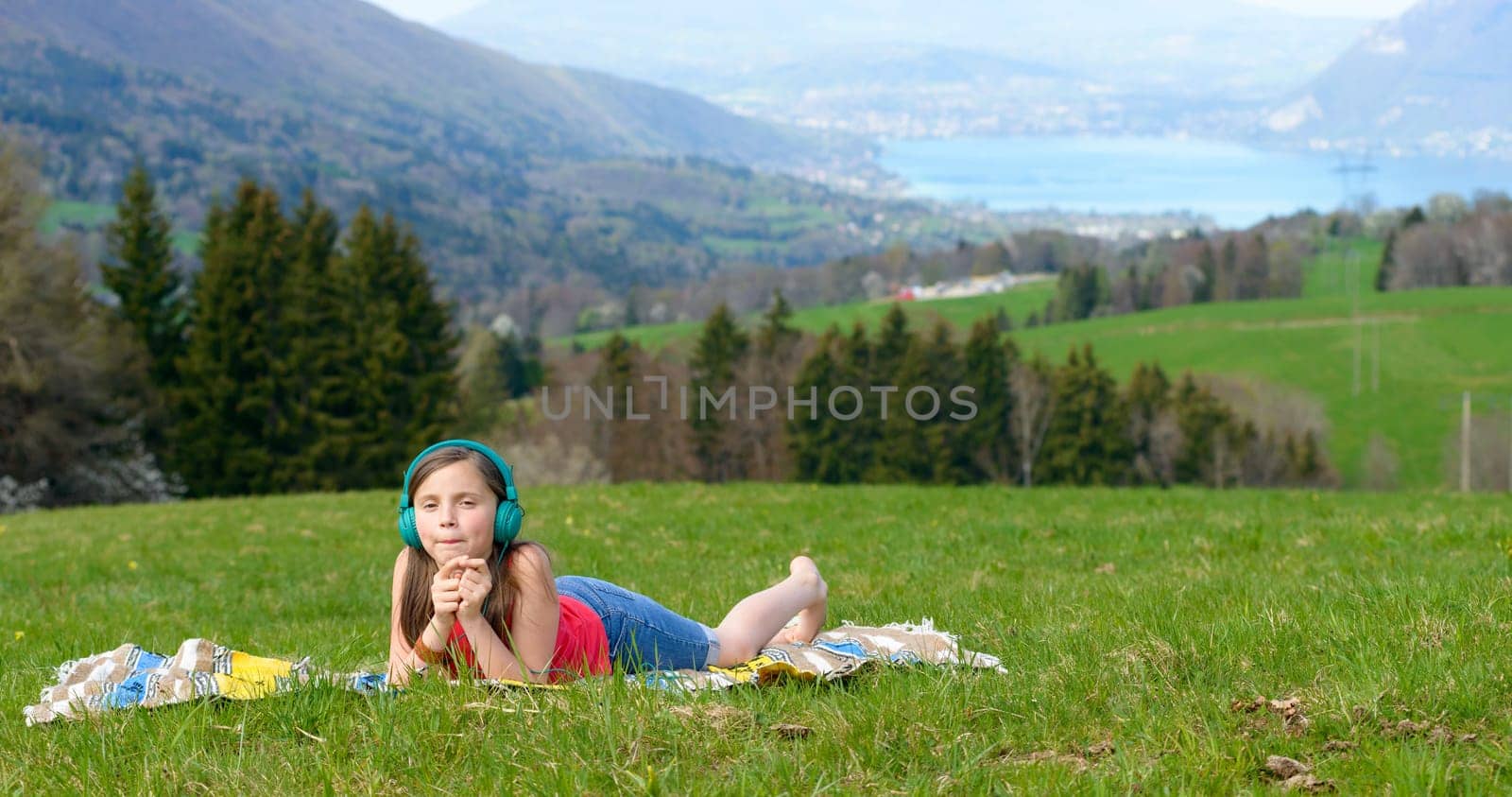 a pretty young girl listening to music in nature