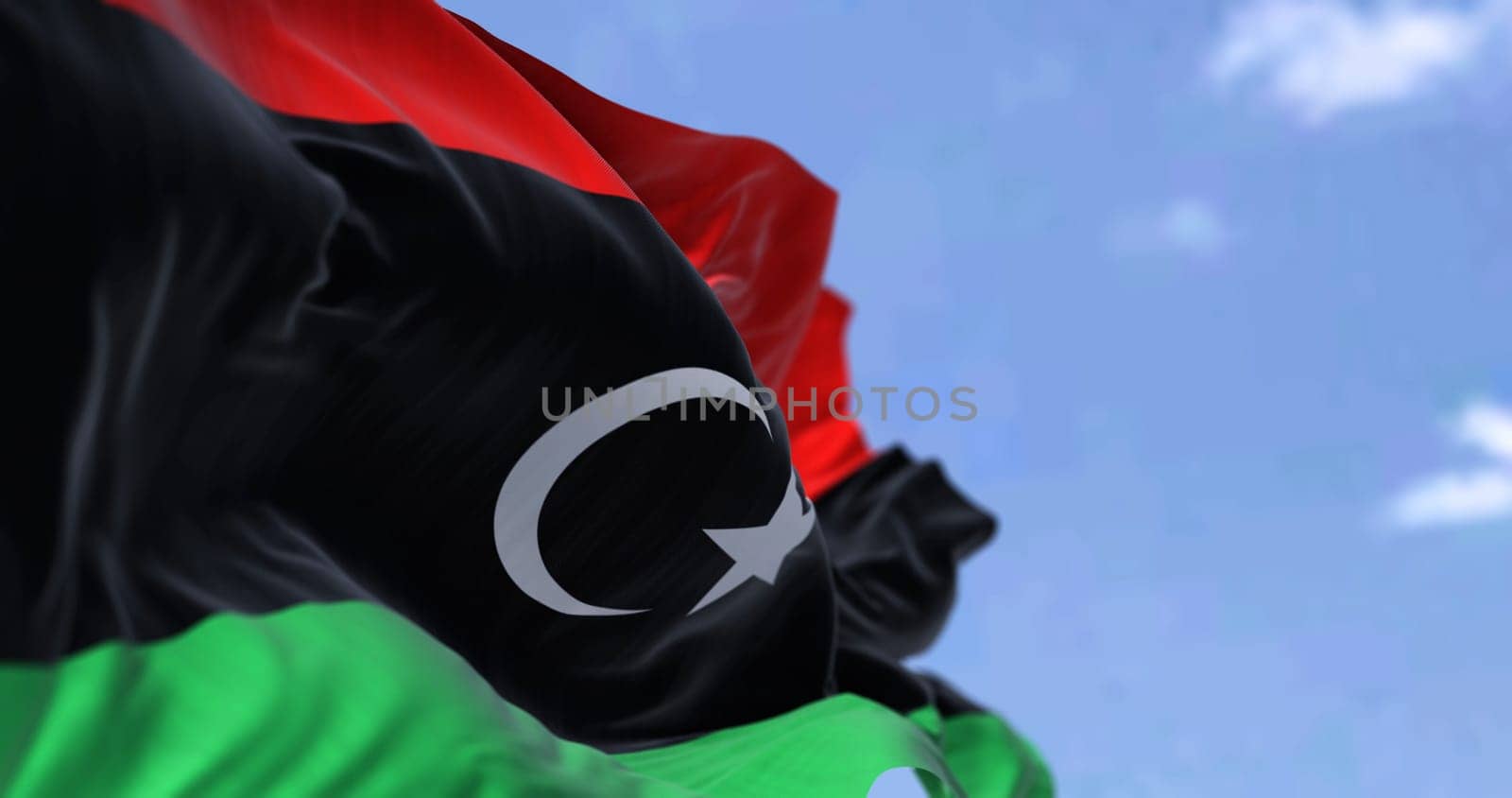 Detail of the national flag of Libya waving in the wind on a clear day. Patriotism. North african country. Selective focus.