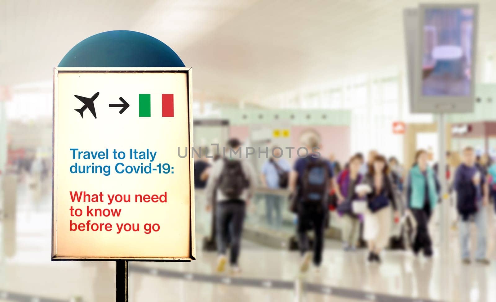 a signal inside an airport that warns about what to know before flying to Italy during the Covid-19 pandemic. Airport security measures and travel restrictions. New Covid-19 variant spread