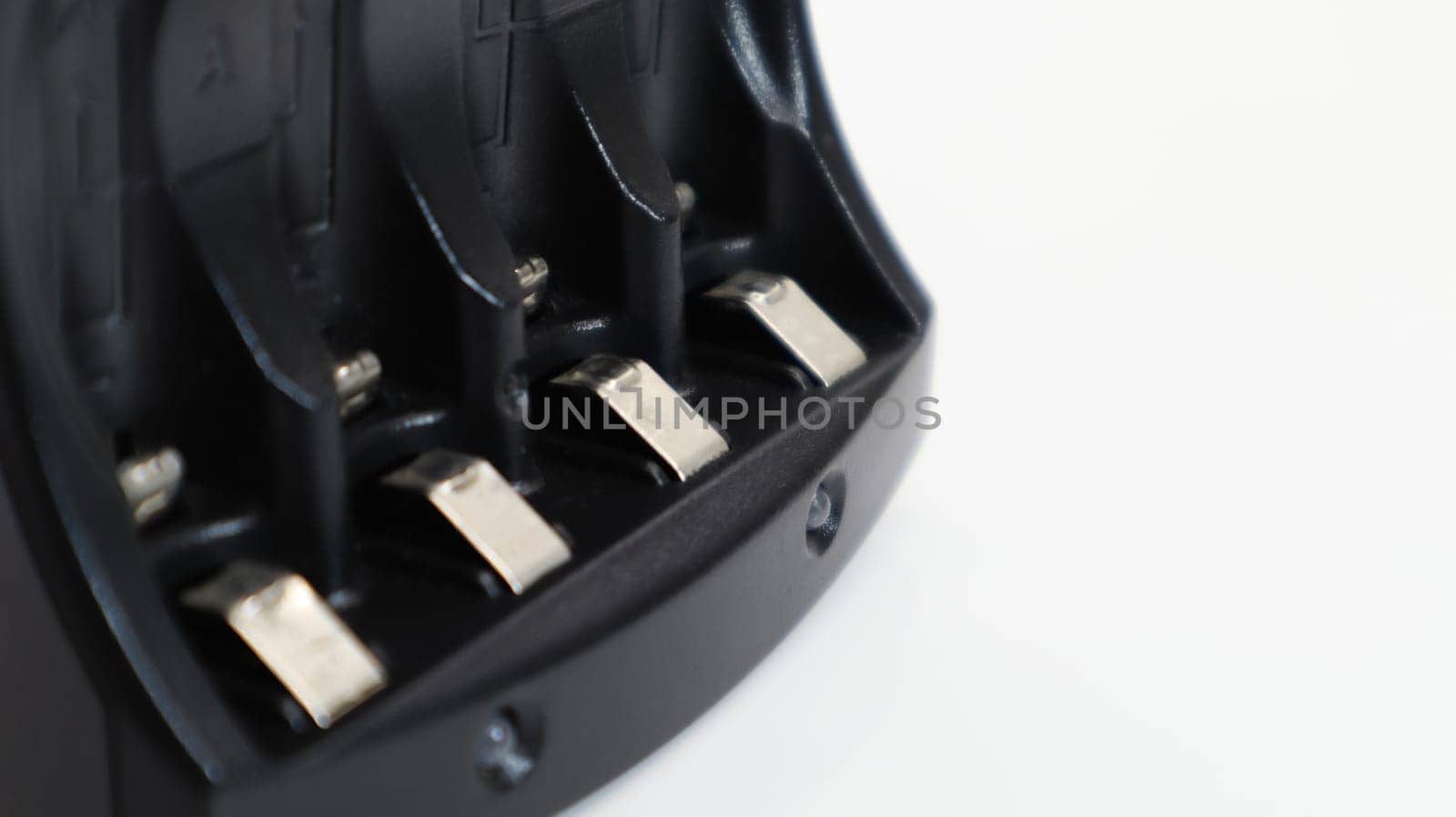 Fast charger for four AA rechargeable batteries in black on a white background. No batteries
