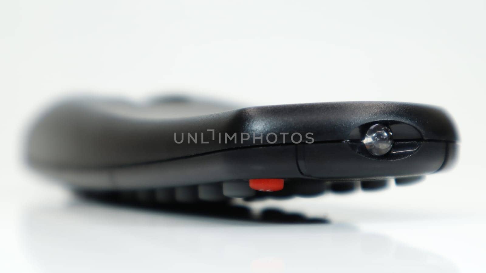 Remote control close-up. Black TV remote control with AAA alkaline batteries on a white background. Battery replacement, spare parts