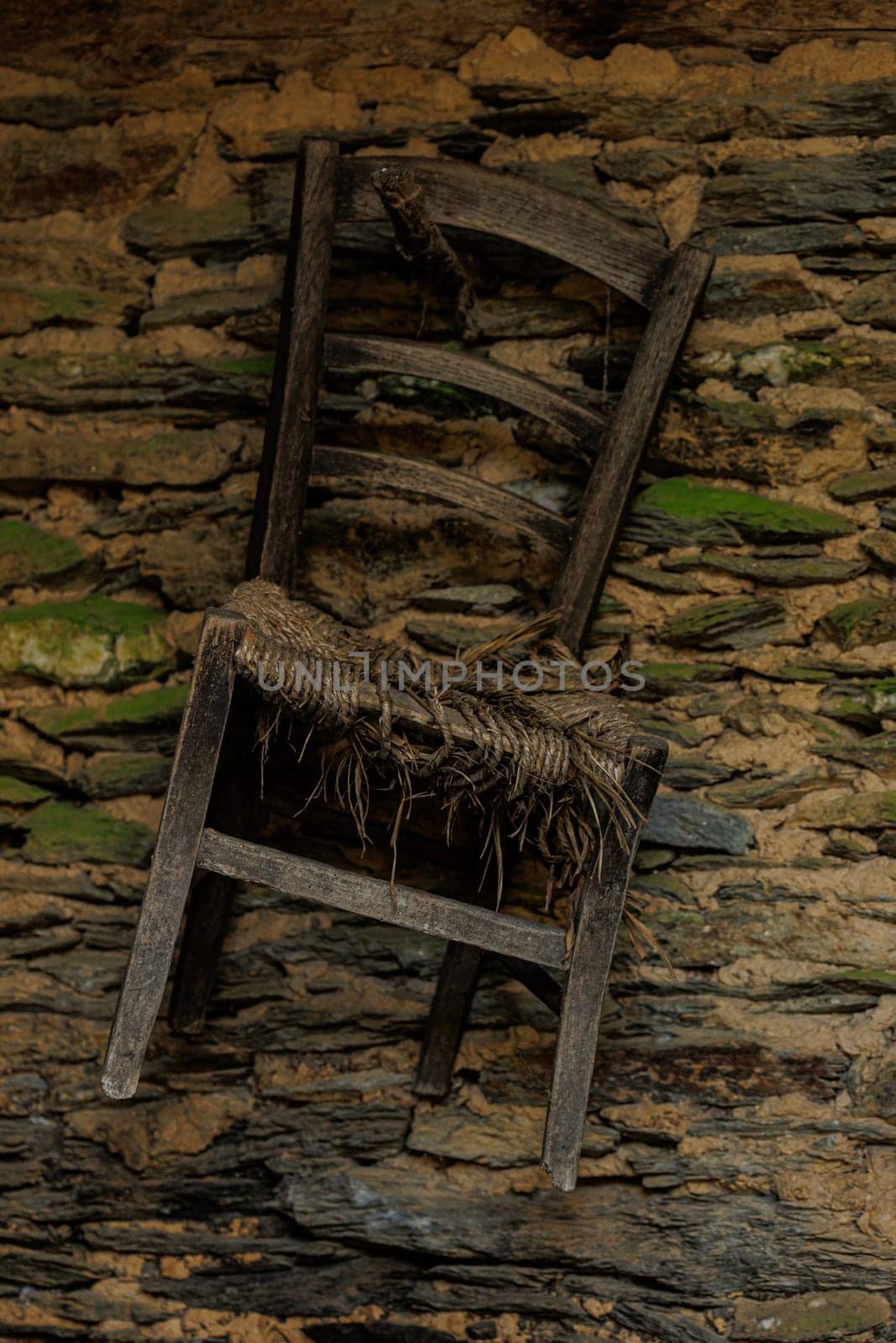 Old chair hanging at the wall