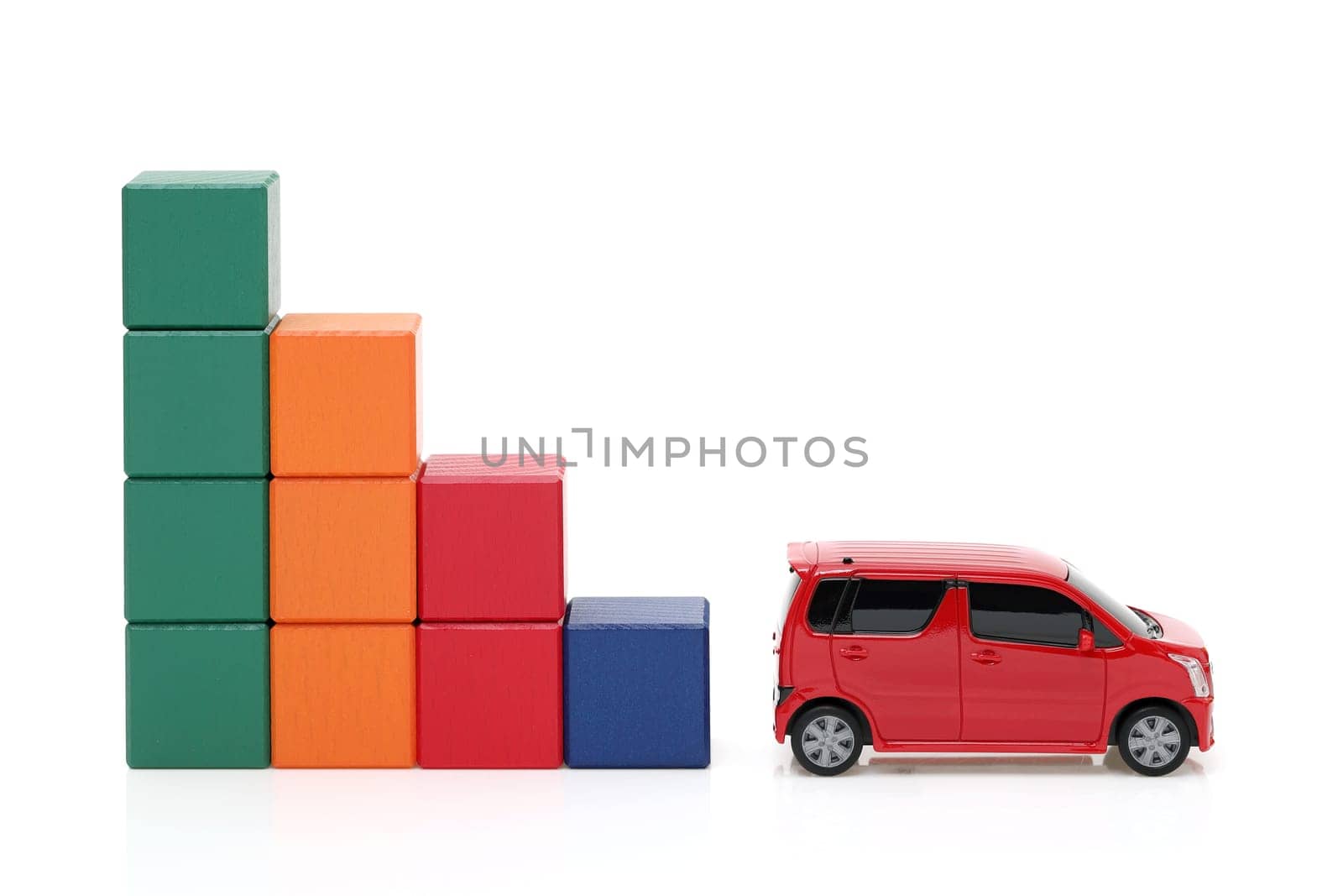 Small toy car and wooden colorful building blocks on white background