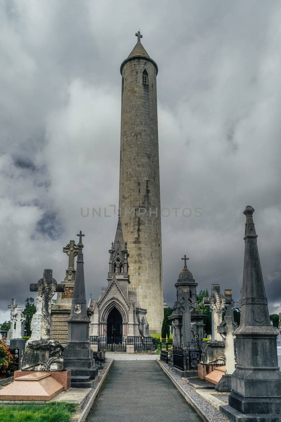Dublin, Ireland, August 2019 Round Tower and ancient graves and tombstones in Glasnevin Cemetery