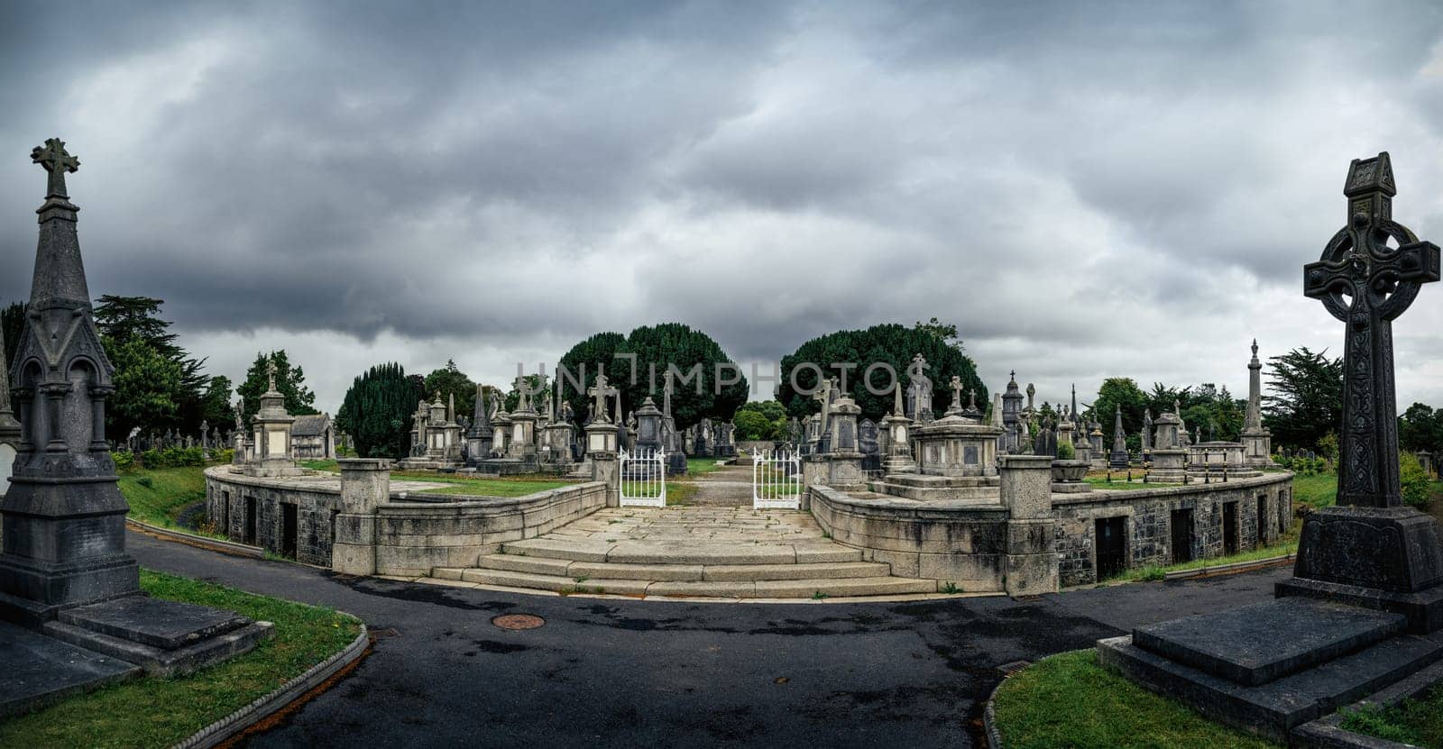 Dublin, Ireland, August 2019 Round mausoleum, cripts, ancient graves and tombstones with Celtic crosses in Glasnevin Cemetery