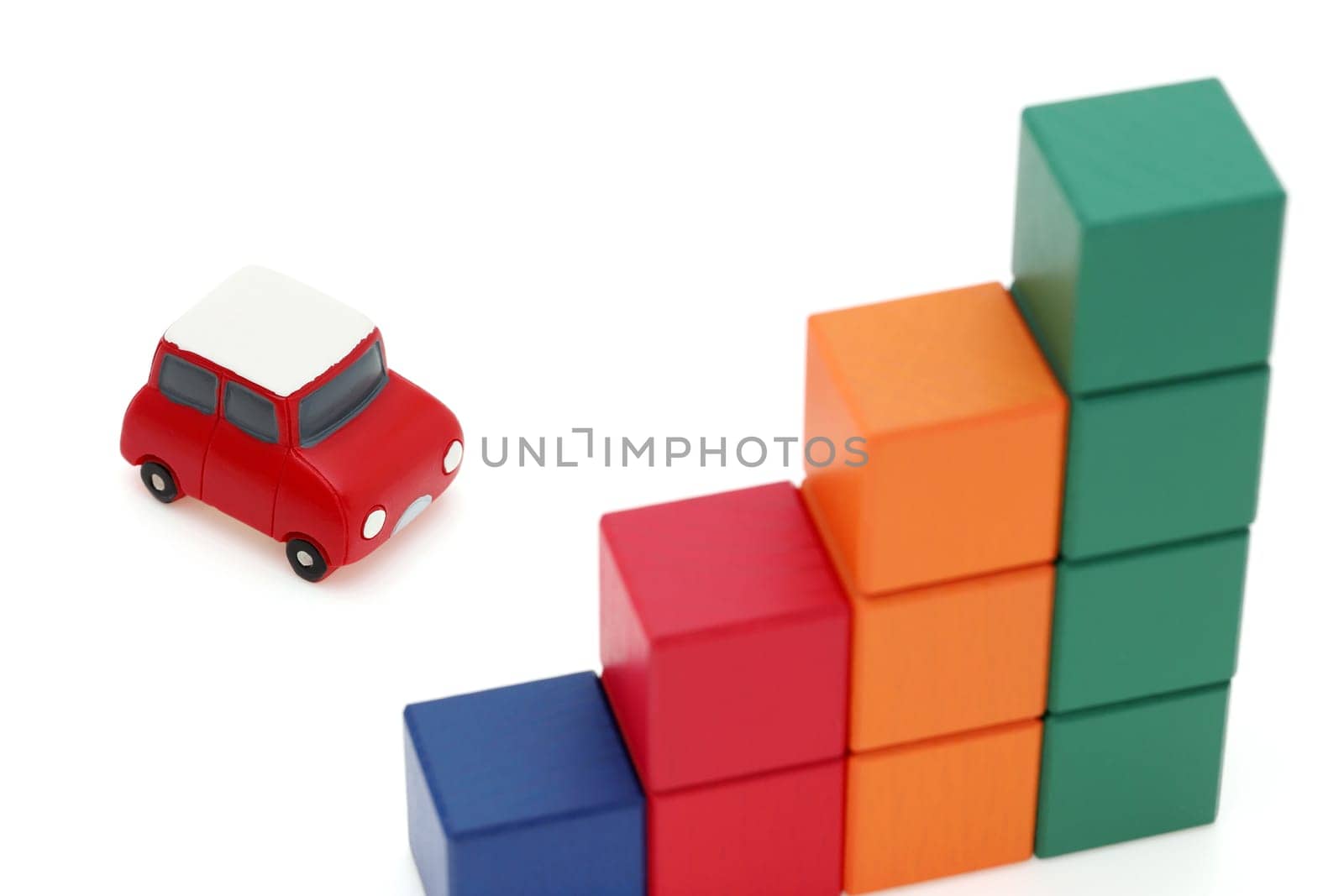 Small toy car and wooden colorful building blocks on white background